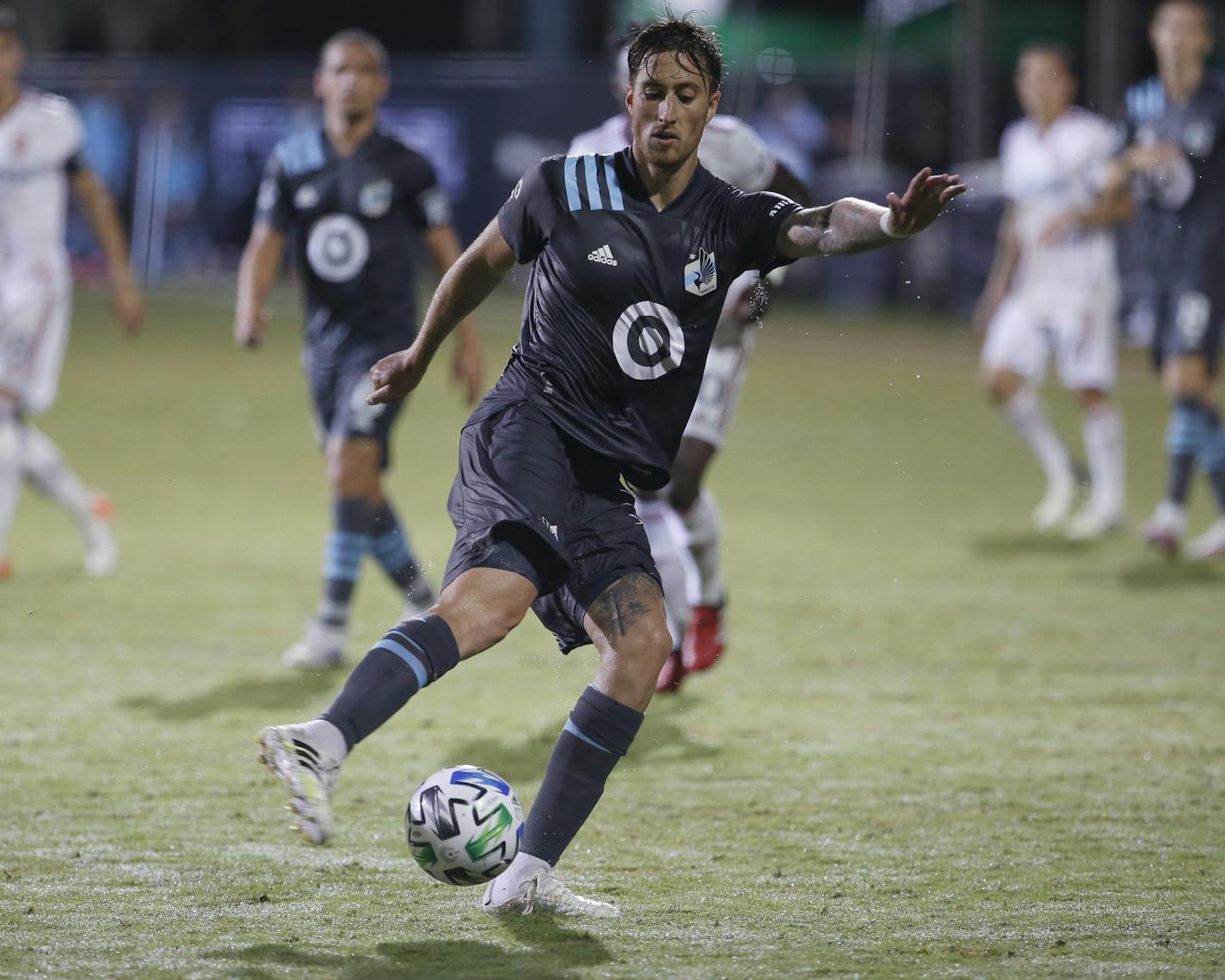 Minnesota United defender Jose Aja (4) drives the ball down tjhe pitch against Real Salt Lake during the second half of a soccer match in Kissimmee, Fla., Saturday, July 18, 2020. (AP Photo/Reinhold Matay)