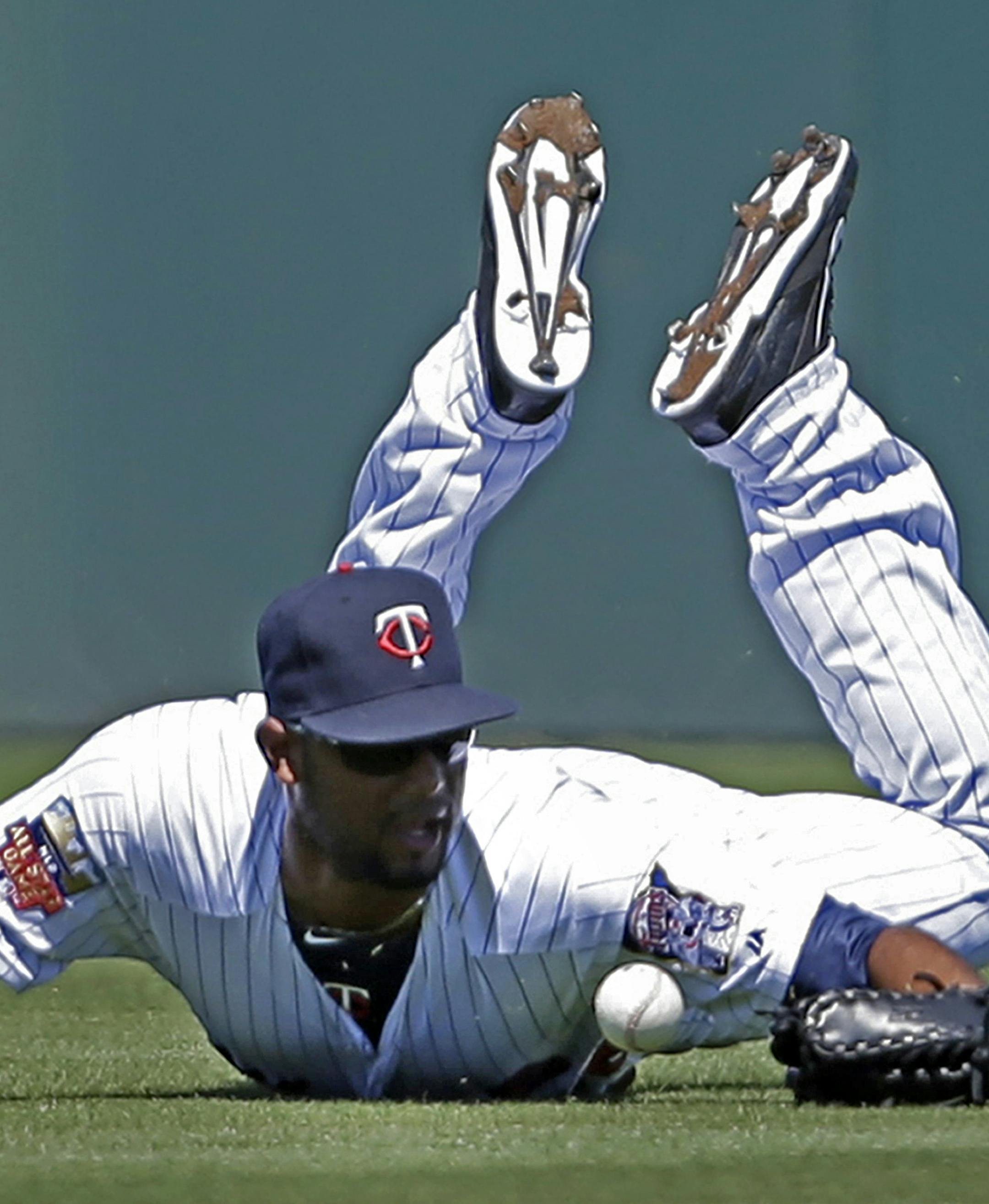 Minnesota Twins center fielder Aaron Hicks (32) dives for a single hit by Boston Red Sox Mike Napoli in the second inning of an exhibition baseball game in Fort Myers, Fla., Thursday, March 13, 2014. (AP Photo/Gerald Herbert)