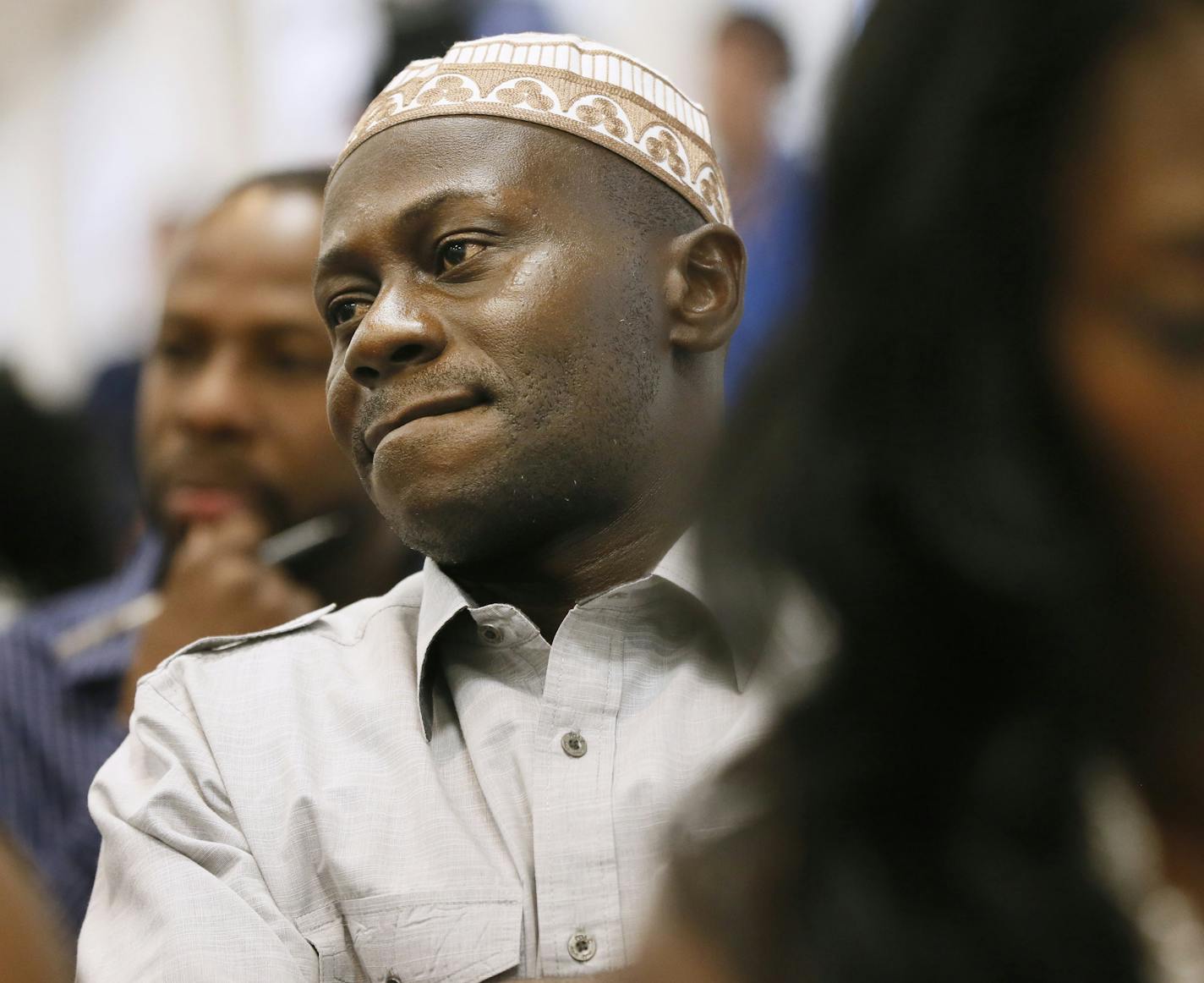 Isaac Owens left from Ghana, Abdullah Kiatamba, and Zoyea Queeglay-Weah both from Liberia now living in Brooklyn Park listened to a panel discussion about ebola. A community meeting was held to address the ebola virus in Liberia and two other West African countries Sunday August 3 , 2014 in Brooklyn Park , MN . ] Jerry Holt Jerry.holt@startribune.com