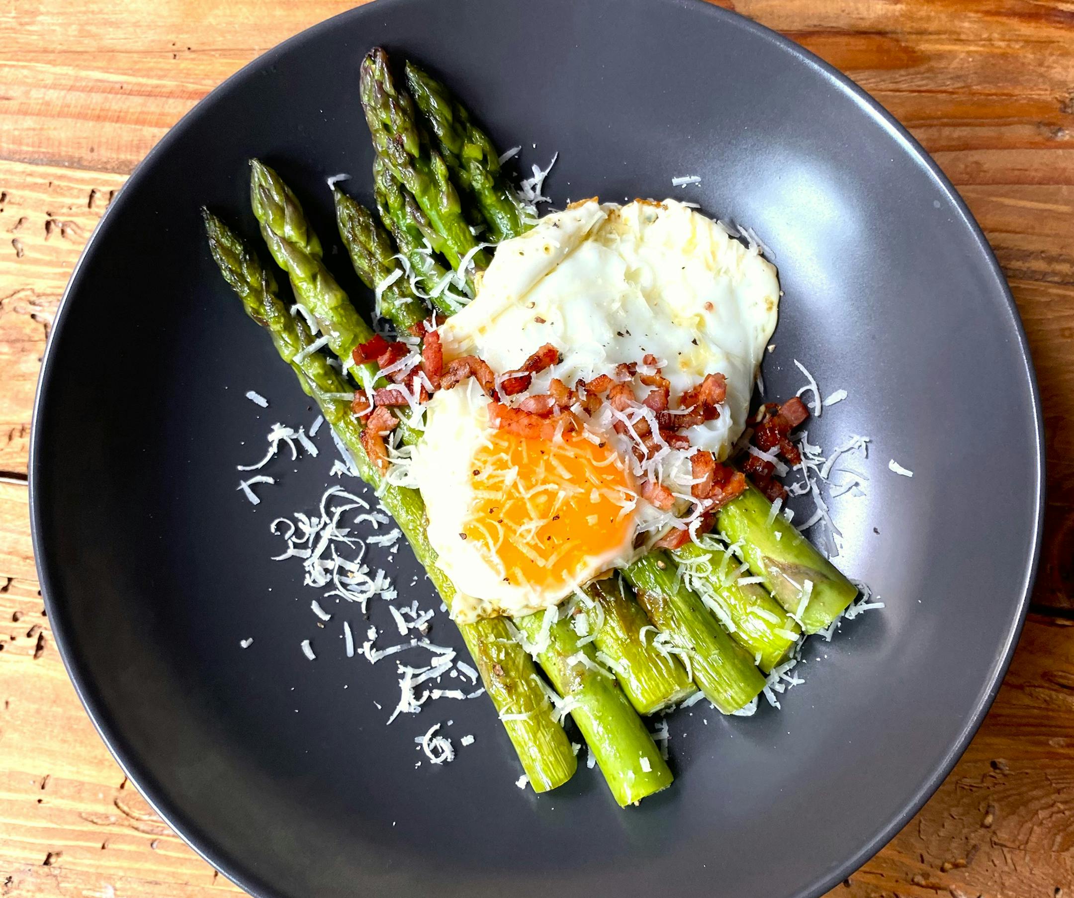 Pan-seared asparagus is topped with pancetta, Parmesan and a fried egg for a light weeknight meal or an elegant first course. Recipe and photo by Meredith Deeds, Special to the Star Tribune