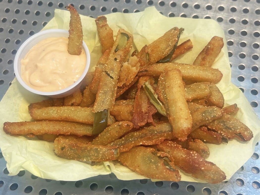 Pickle fries are served with a side of chipotle sauce.