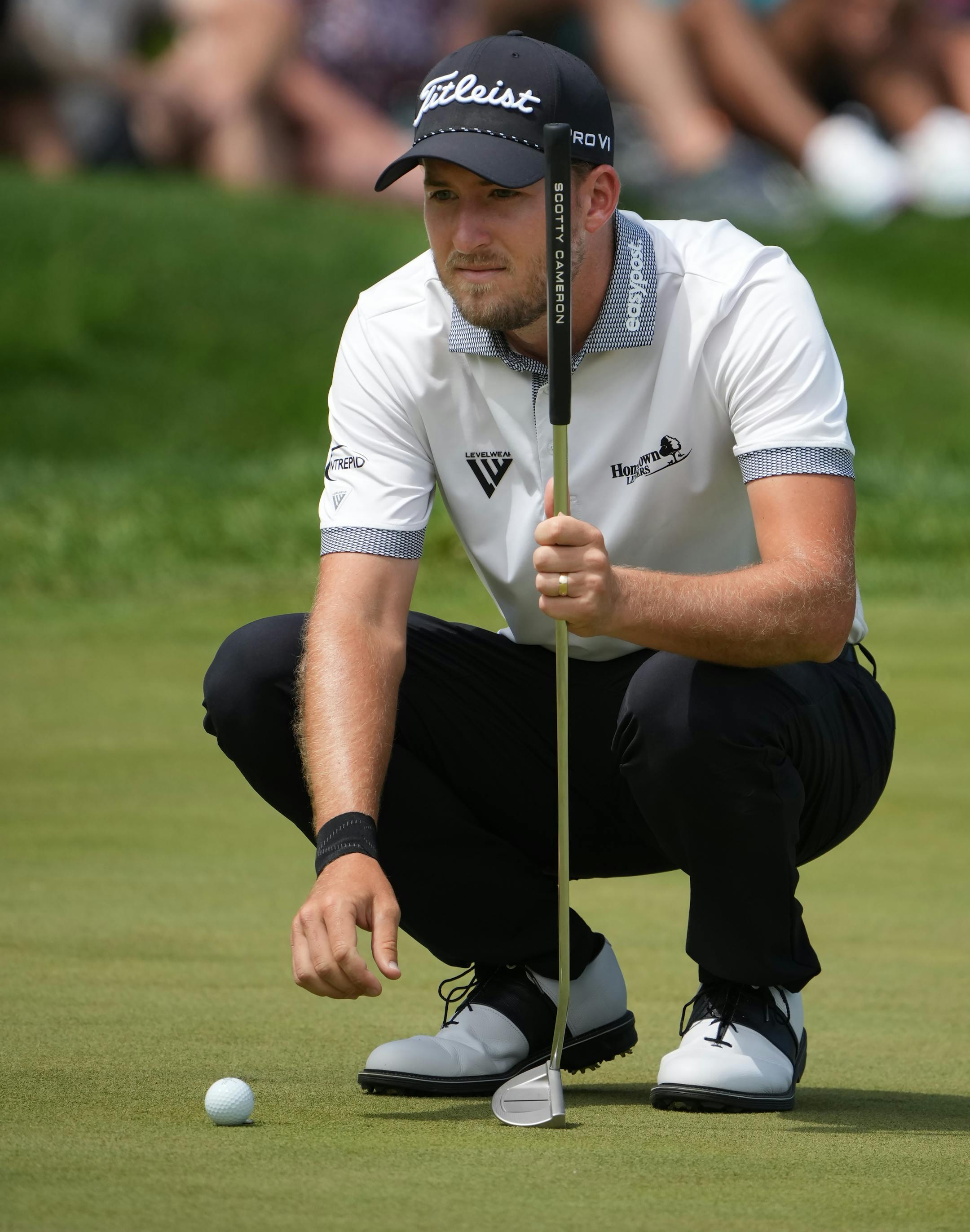 3M Open leader Lee Hodges measures his putt on the 7th hole at TPC Twin Cities in Blaine on Sunday.
