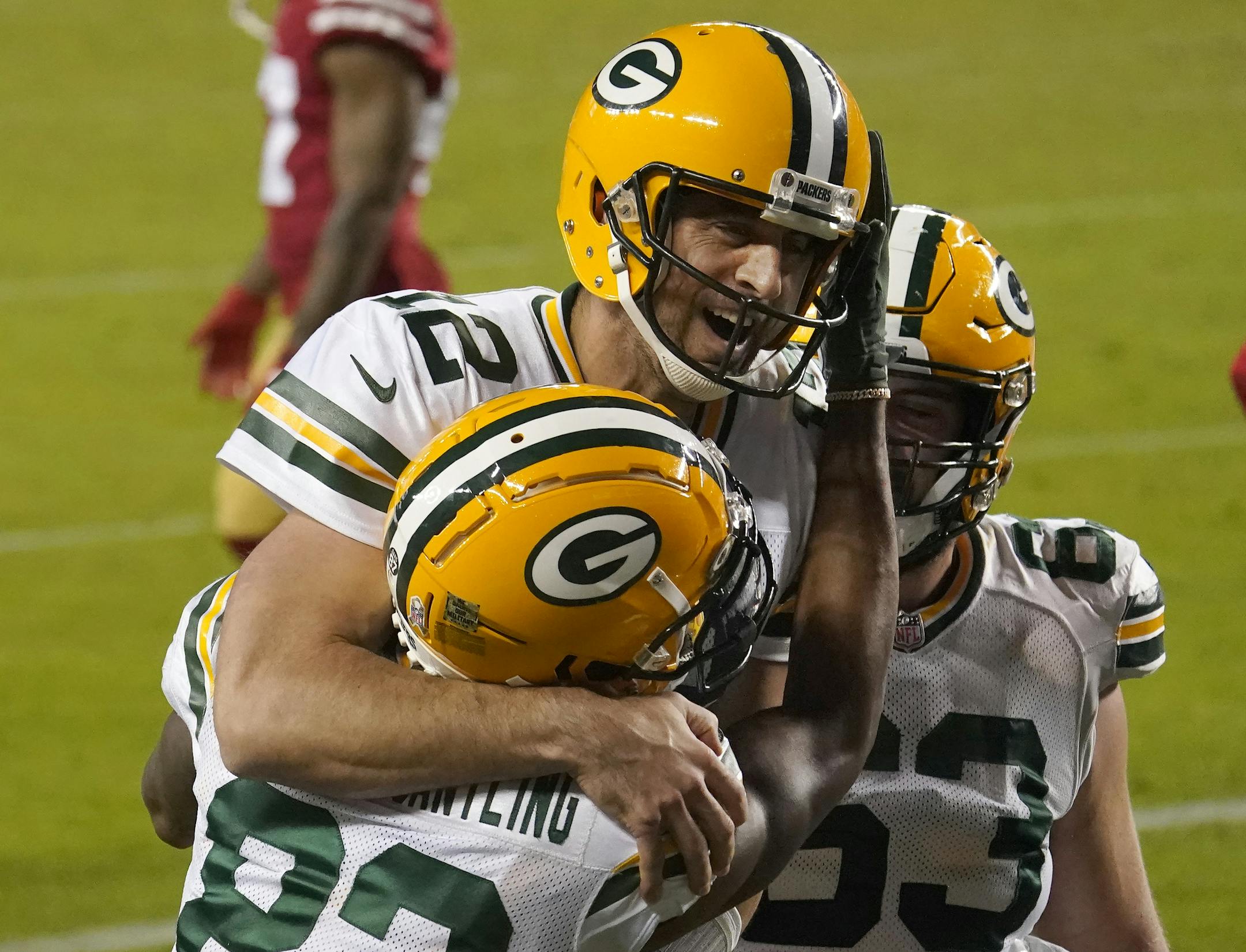 Green Bay Packers wide receiver Marquez Valdes-Scantling, bottom left, and quarterback Aaron Rodgers (12) celebrate after connecting on a touchdown pass during the second half of an NFL football game against the San Francisco 49ers in Santa Clara, Calif., Thursday, Nov. 5, 2020. (AP Photo/Tony Avelar)