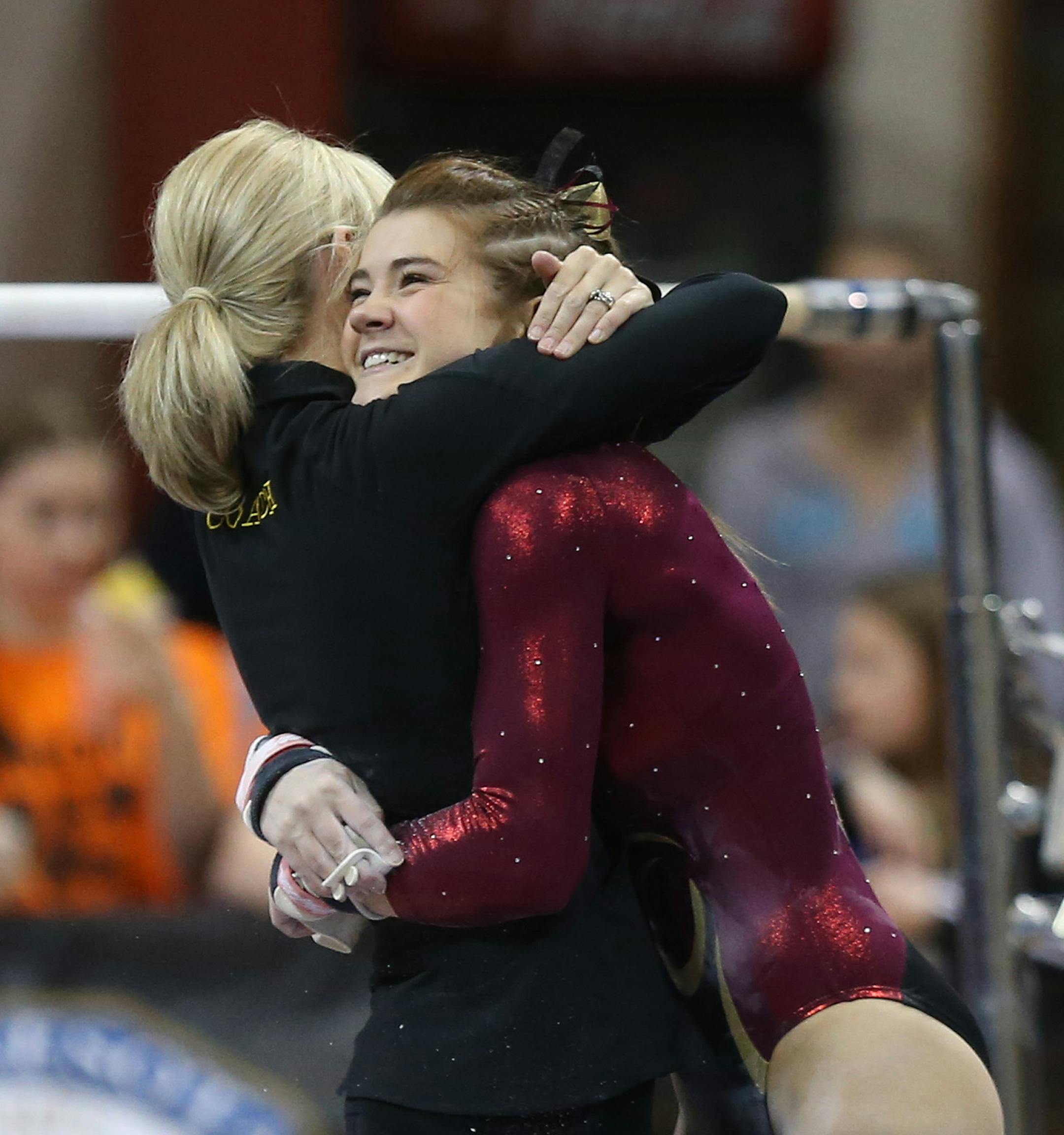Northfield's Bailey DuPay got a hug from her coach after performing on the uneven bars during the Class 2A gymnastics state meet at the Sport Pavilion in Minneapolis Saturday, February 22, 2014 ] (KYNDELL HARKNESS/STAR TRIBUNE) kyndell.harkness@startribune.com