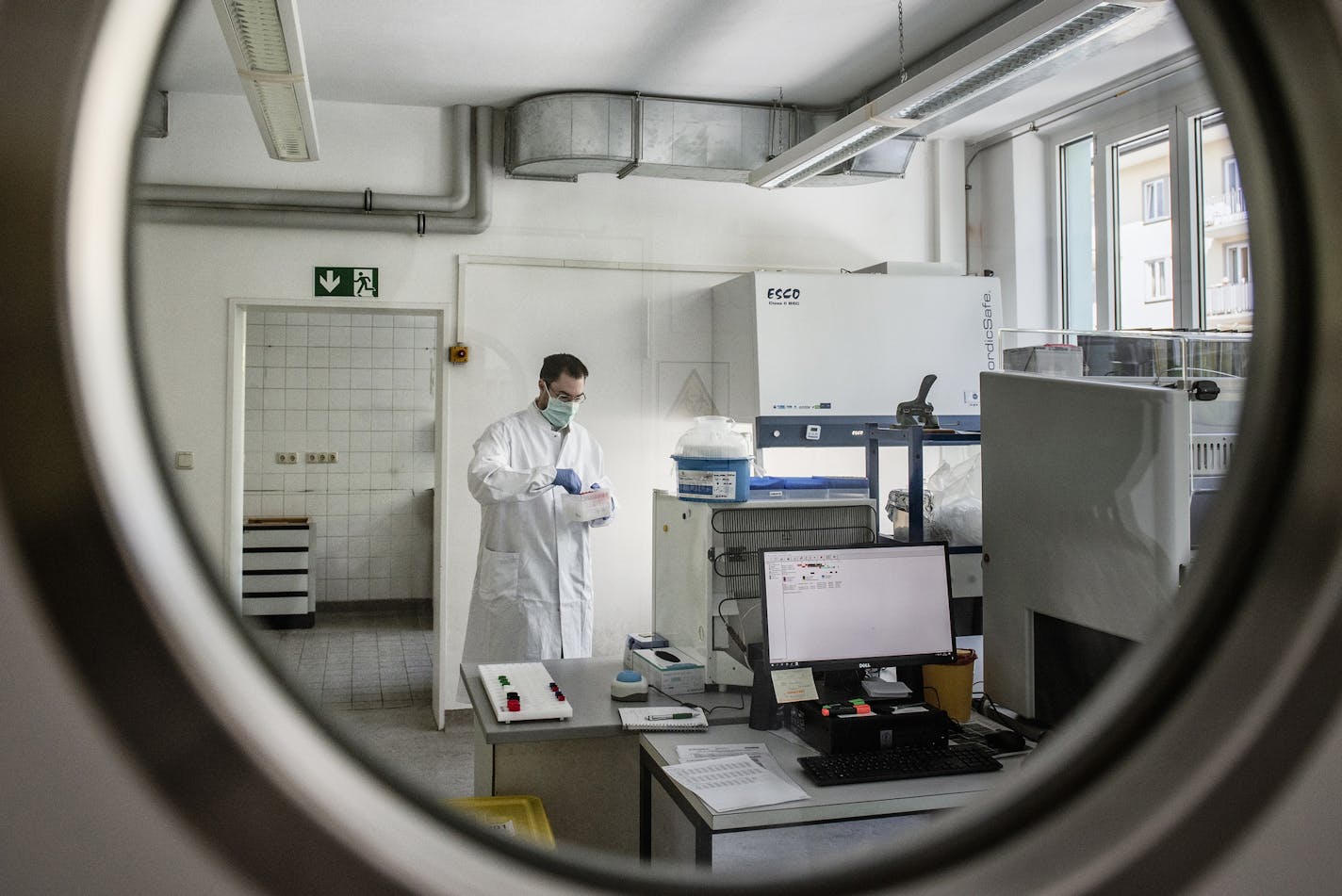 Dr. Andreas Wieser prepares to test a blood sample for the coronavirus, in Munich, April 17, 2020. Germany was the first large democracy to contain the spread of the coronavirus and is now the first to methodically go about reopening its economy by testing for antibodies. (Laetitia Vancon/The New York Times)