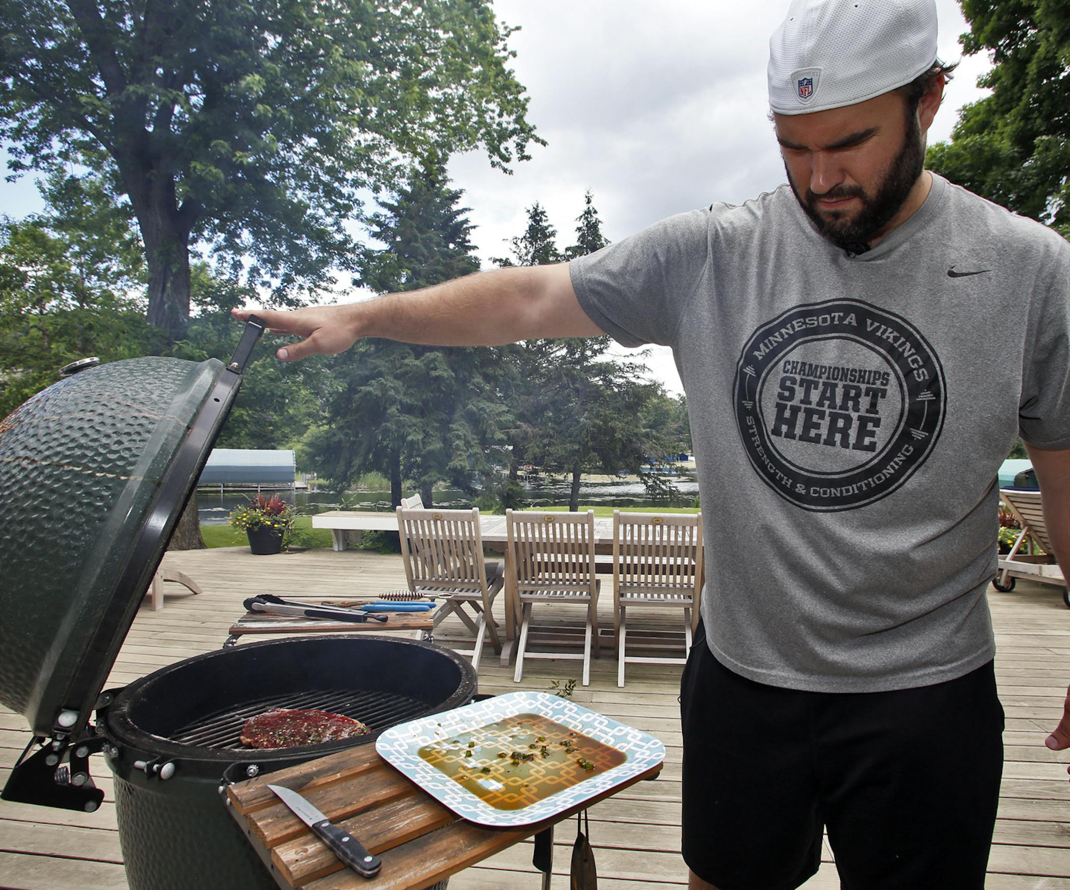 Feature on professional athletes who take time out of their sport schedules to grill food outdoors in summertime. Vikings center John Sullivan prepared seasonings in his Woodland kitchen, then grilled a flank steak in a barbecue cooker on his deck. (MARLIN LEVISON/STARTRIBUNE(mlevison@startribune.com ORG XMIT: MIN1306291435342620