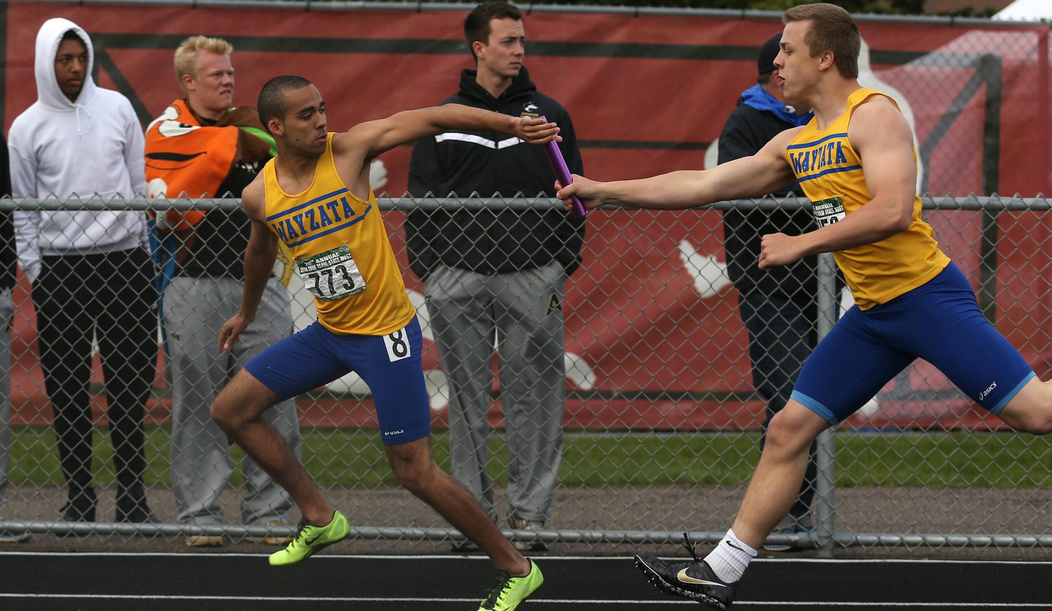 Wayzata’s Foster Conzet, right, handed off the baton to teammate Keante Johnson during the 4x200 meters at the True Team state meet.
