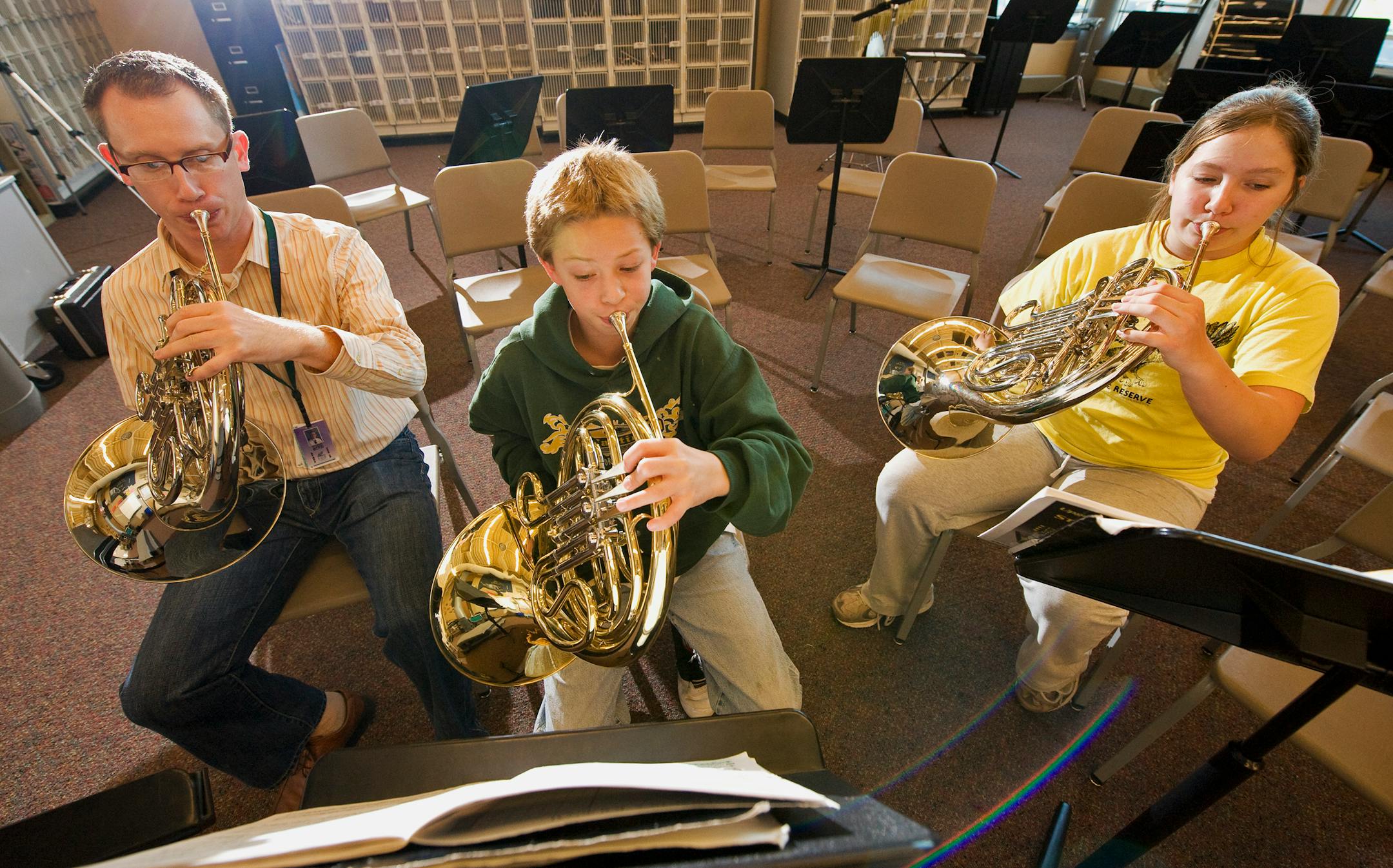 DAVID BREWSTER � dbrewster@startribune.com Thursday_10/30/08_Crystal FAIR School Band director Todd Boyd works with two students, Sam Loben and Annika Leitch-Lodge (both 7th graders), on the French horn.