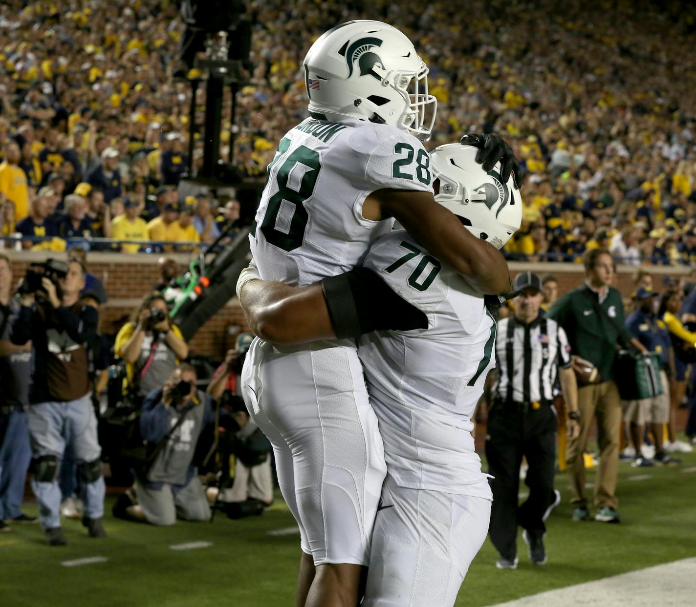 Michigan State running back Madre London (28) celebrates with teammate Tyler Higby (70) in the end zone after scored on a 16-yard pass reception against Michigan at Michigan Stadium in Ann Arbor, Mich., on Saturday, Oct. 7, 2017. (Eric Seals/Detroit Free Press/TNS) ORG XMIT: 1212836