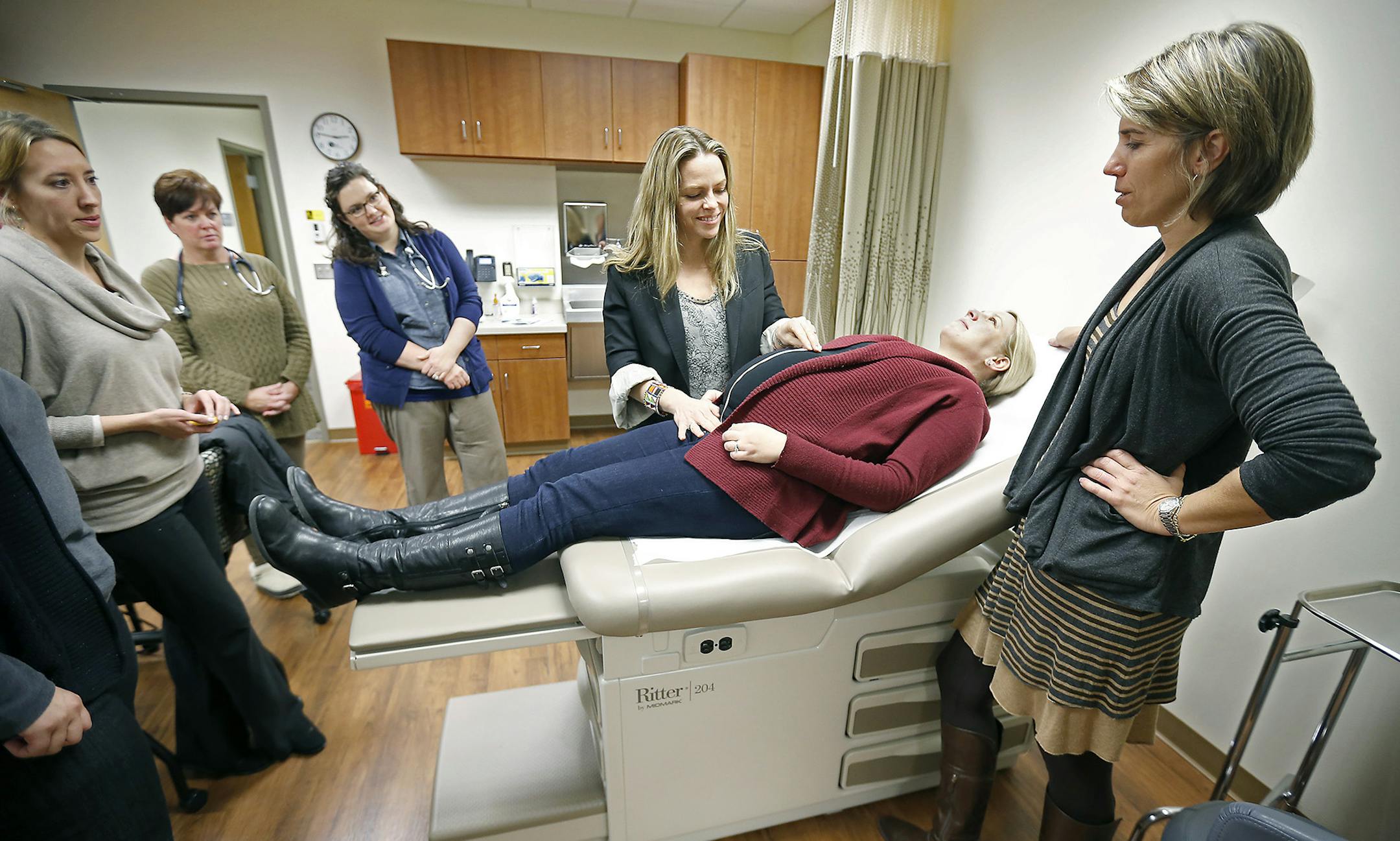 Instructor Julie Ann Vingers, right, led a group of Bethel College nurse-midwife students as they practiced their exams on pregnant volunteer, Stefanie Wernsman at Bethel College, Friday, November 14, 2014 in Arden Hills, MN. ] (ELIZABETH FLORES/STAR TRIBUNE) ELIZABETH FLORES • eflores@startribune.com