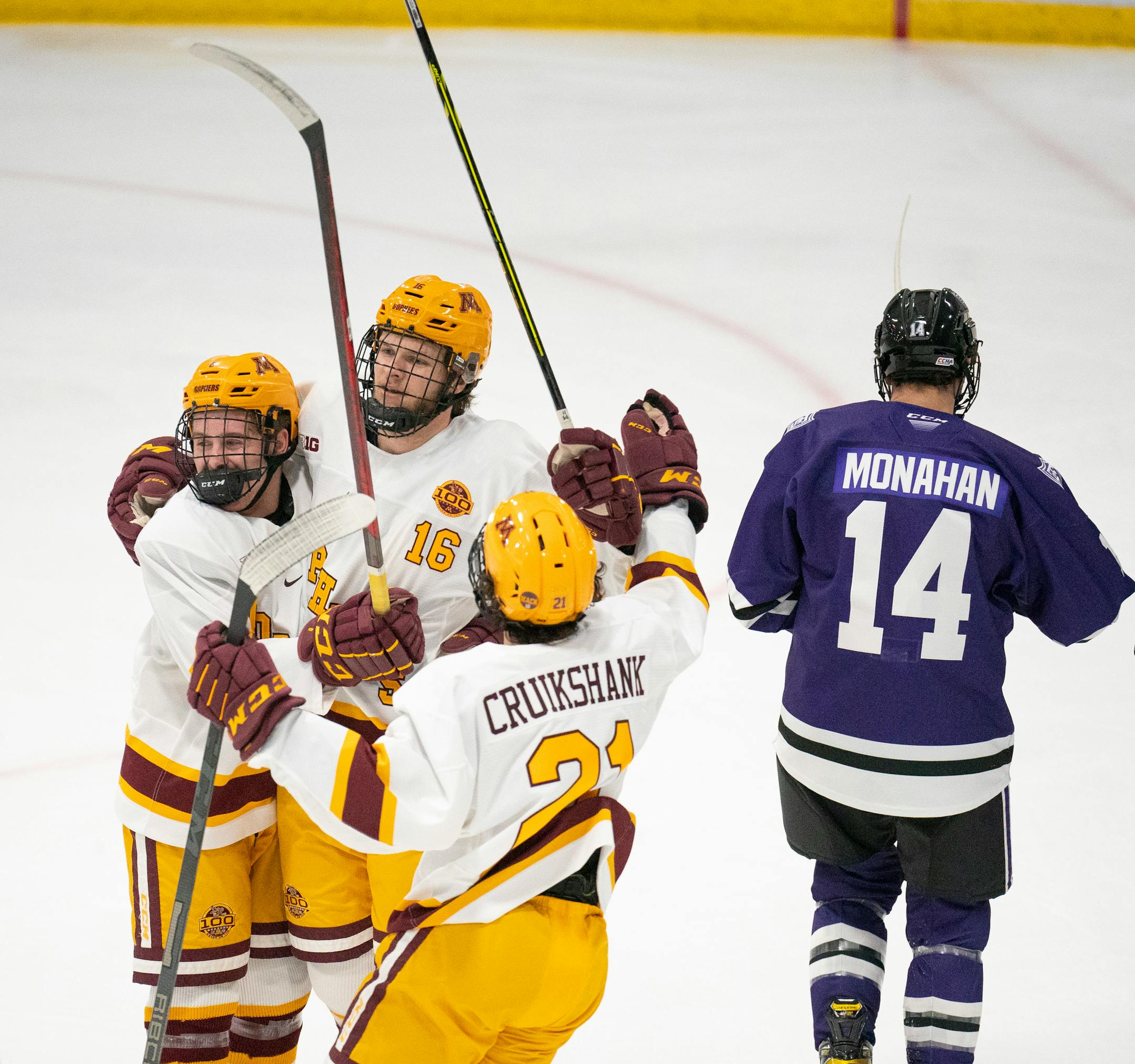 Gophers defenseman Mike Koster (6) and Gophers forward Grant Cruikshank (21) converged on Gophers forward Colin Schmidt (16) after he scored in the first period to tie the game 1-1 Sunday afternoon, Jan. 2, 2022 at Doug Woog Arena in South St. Paul.