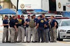 The FBI gather early Monday, June 20, 2016, in front of Pulse Nightclub at the mass shooting scene in Orlando. Federal investigators promised to provi