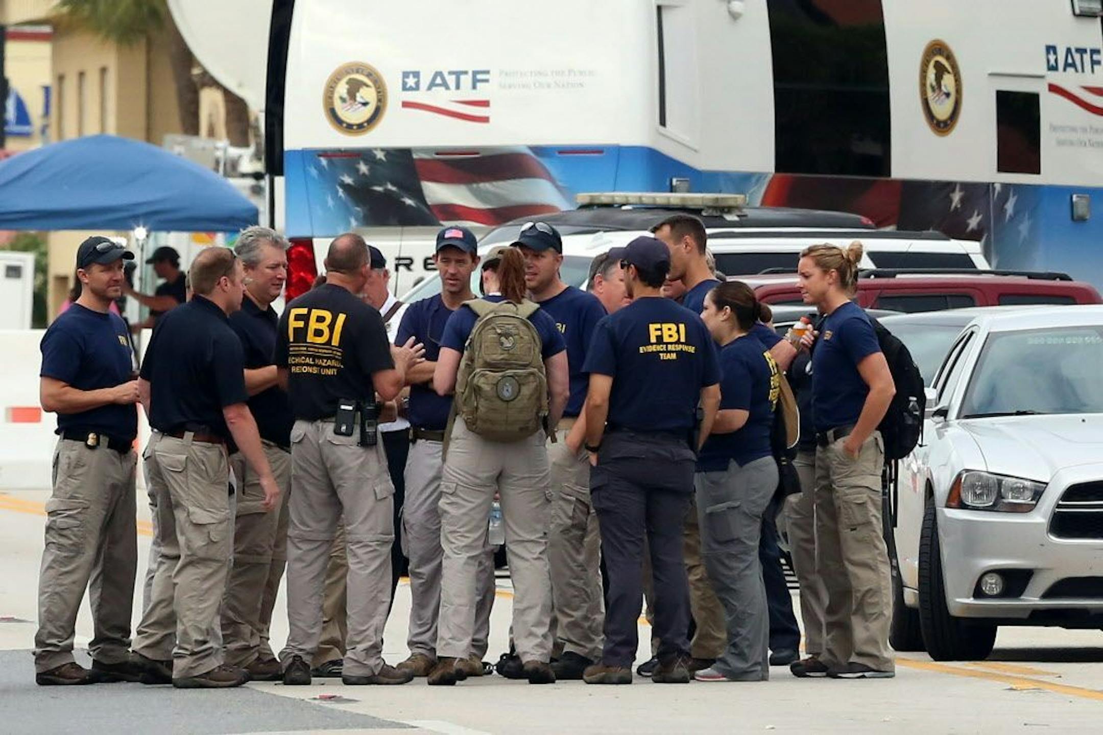 The FBI gather early Monday, June 20, 2016, in front of Pulse Nightclub at the mass shooting scene in Orlando. Federal investigators promised to provide more insight as to what was happening inside the Pulse nightclub after a gunman started a deadly assault that was the worst mass shooting in modern U.S. history.