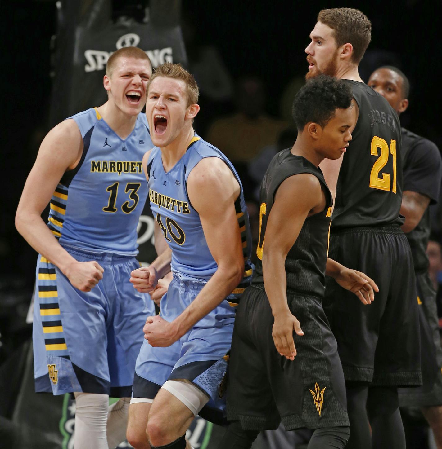 Marquette forward Henry Ellenson (13) and center Luke Fischer react to a foul called on Arizona State during the first half of an NCAA college basketball game in the Legends Classic, Tuesday, Nov. 24, 2015, in New York. Arizona State guard Tra Holder and forward Eric Jacobsen (21) are at right. Marquette defeated Arizona State 78-73 in overtime. (AP Photo/Kathy Willens)