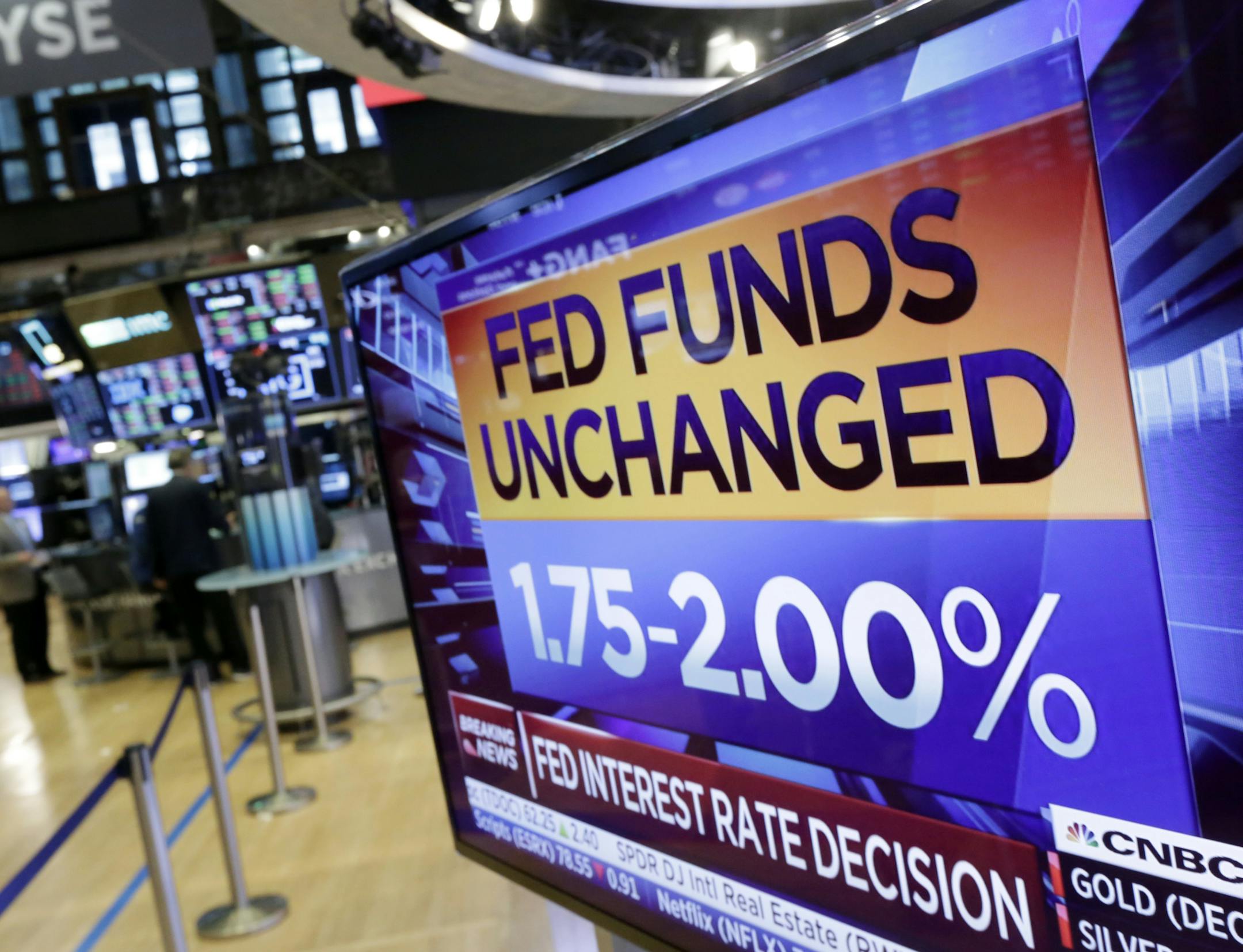 A screen on the floor of the New York Stock Exchange shows the rate decision of the Federal Reserve, Wednesday, Aug. 1, 2018. The Federal Reserve is leaving its benchmark interest rate unchanged while signaling further gradual rate hikes in the months ahead as long as the economy stays healthy. (AP Photo/Richard Drew) ORG XMIT: NYRD105
