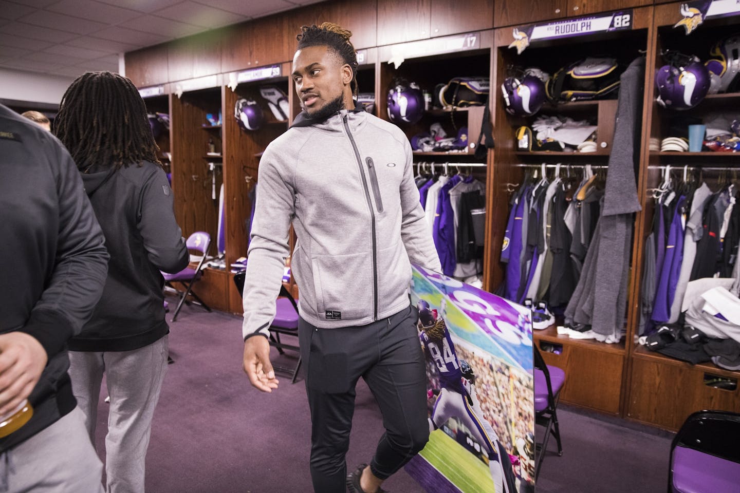 Cordarrelle Patterson leaves the locker room holding a photo of himself.