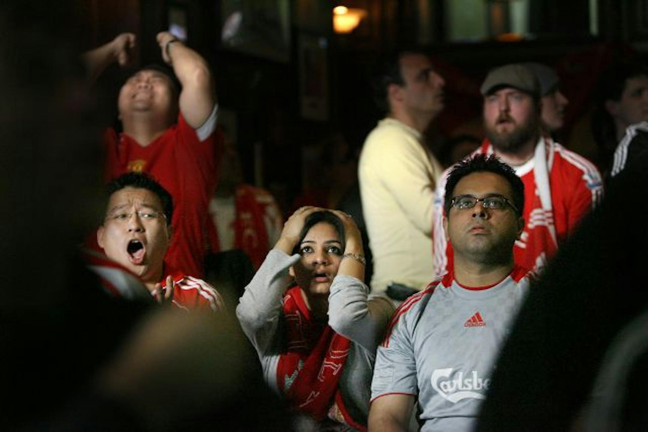 Bhupendra Rai, left, Amrita Dhaliwal, center, and Manvir Dhaliwal, originally of India, joined soccer fans to watch a 7:30 am live soccer broadcast between Liverpool and Manchester United at Brit's Pub in downtown Minneapolis.