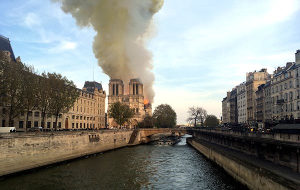Notre Dame cathedral is burning in Paris, Monday, April 15, 2019. Massive plumes of yellow brown smoke is filling the air above Notre Dame Cathedral a