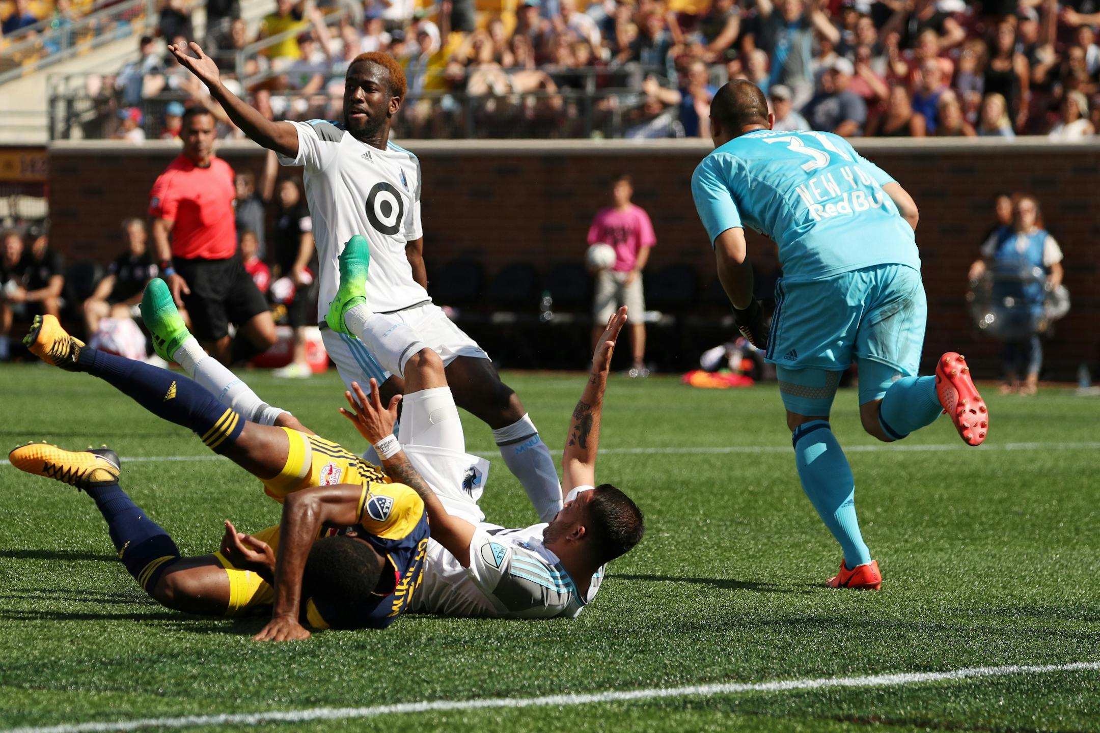 New York Red Bulls goalkeeper Luis Robles (31) made the save as Minnesota United midfielder Miguel Ibarra (10) went down after he got tangled up with New York Red Bulls defender Michael Murillo (62) while dribbling the ball to the goal in the second half.