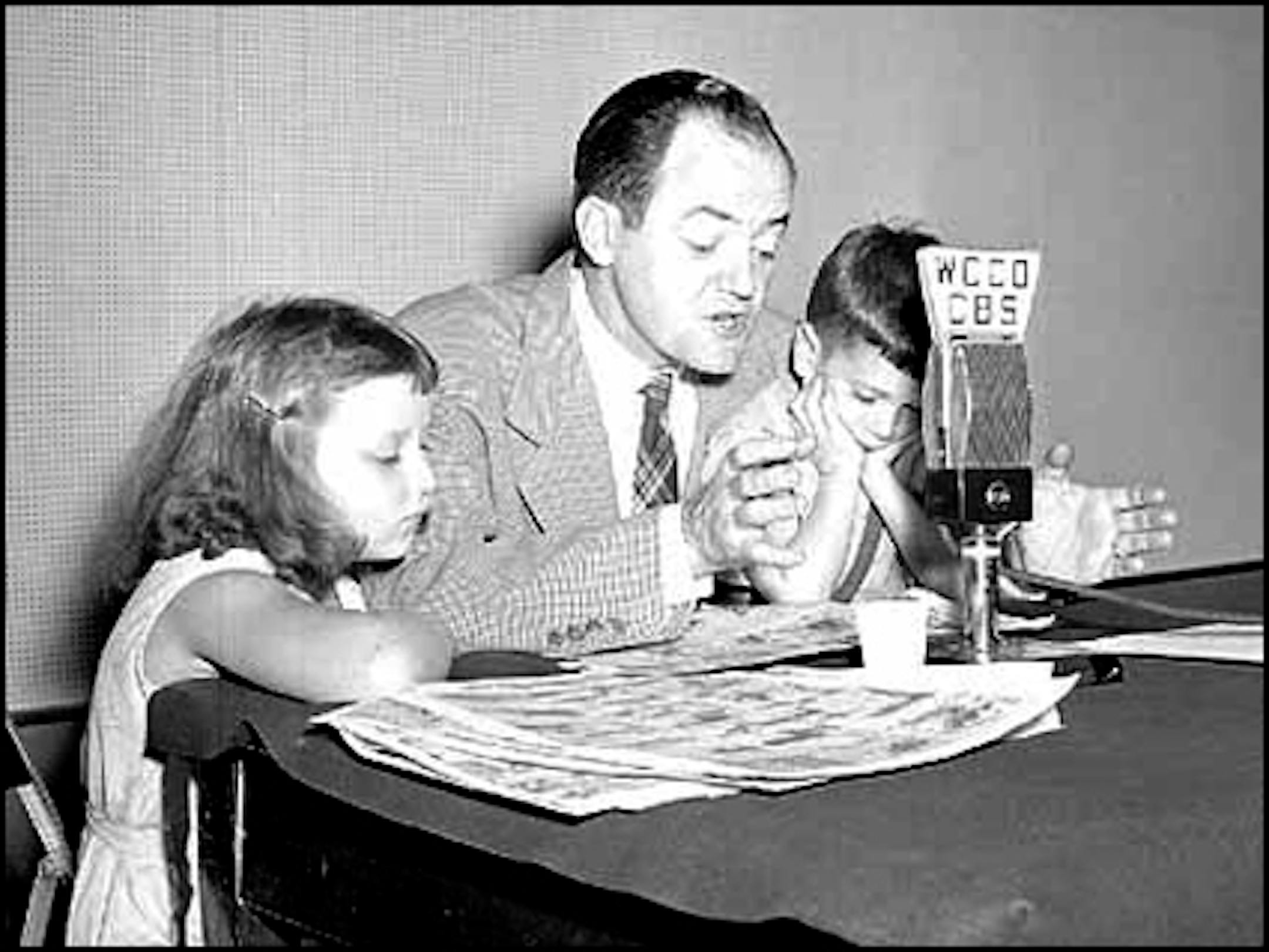 Aug. 18, 1946: With daughter Nancy and Skipper by his side, Mayor Hubert Humphrey reads the funnies to WCCO listeners during a polio outbreak.