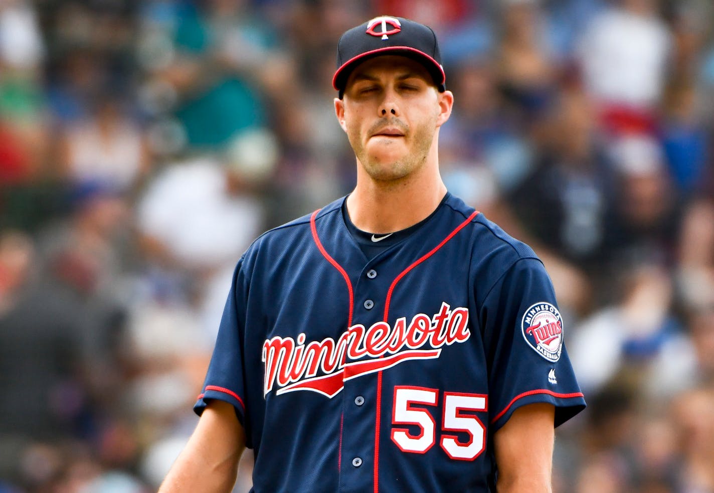 Minnesota Twins relief pitcher Taylor Rogers (55) looks on after Chicago Cubs' Ian Happ (8) hit a home run in the fifth inning a baseball game on Sunday, July 1, 2018, in Chicago. (AP Photo/Matt Marton)