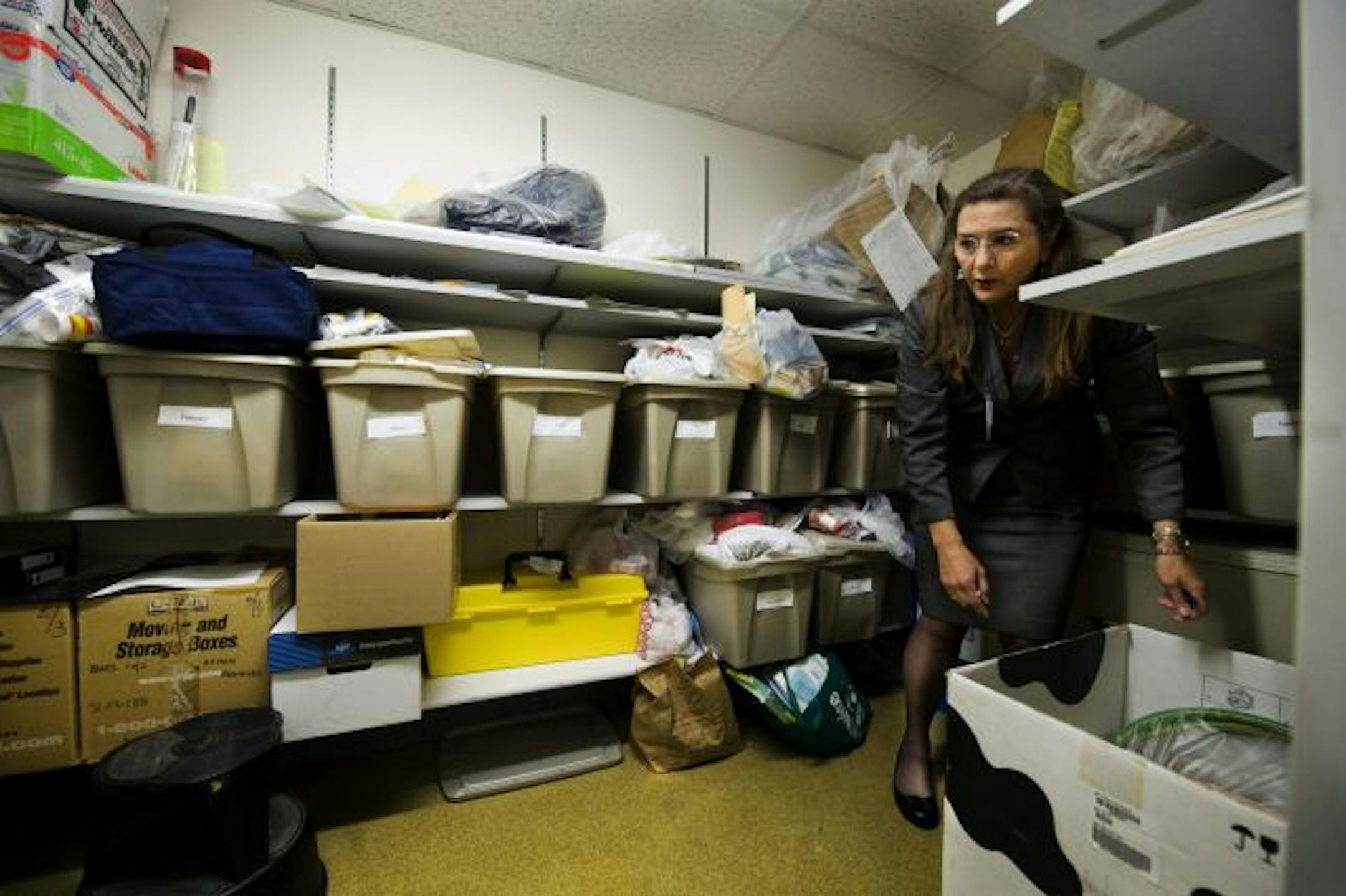 Dr. Lindsay Thomas shows the storage room where personal effects of the deceased are kept temporarily. While the facility was recently re-accredited, inspectors did note space and security issues.