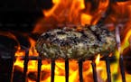 A Pork Burger cooking on the grill in Port Ewen, N.Y., May 16, 2010. Traditionally made out of beef, hamburgers have evolved to include ingredients su