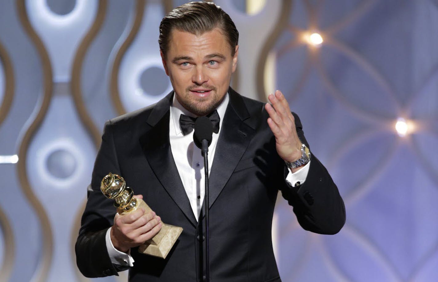 Leonardo DiCaprio accepts the award for best actor in a motion picture comedy for his role in "The Wolf of Wall Street" during the 71st annual Golden Globe Awards.