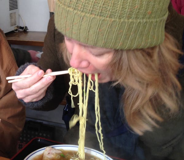 Eating ramen takes some practice, as this American visitor discovered at a Tokyo ramen stand.