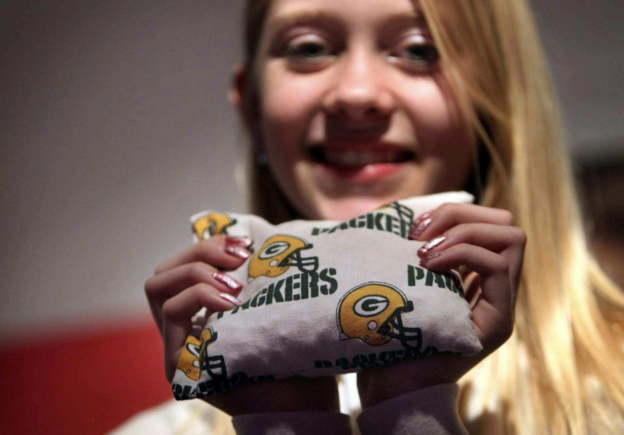 Morgan Rohwer, 12, a 7th grader at Valley Middle School, with one of her corn cozies creations she made for her younger sister - a Packers fan. Rohwer was seen at home Friday, Dec. 28, 2012, in Apple Valley, MN.