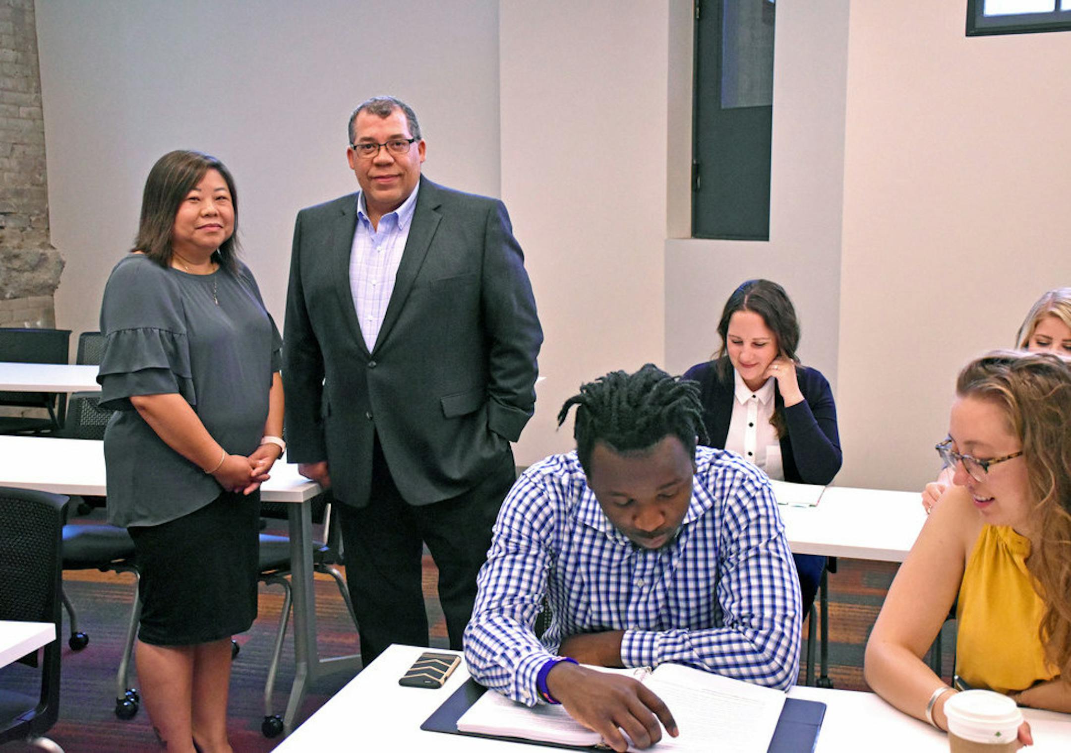 May Xiong (left), vice president of employment readiness atf Project for Pride in Living (PPL) and PPL CEO Paul Williams at PPL's career center on E. Franklin Avenue.
Photo: Laura Dunford/PPL