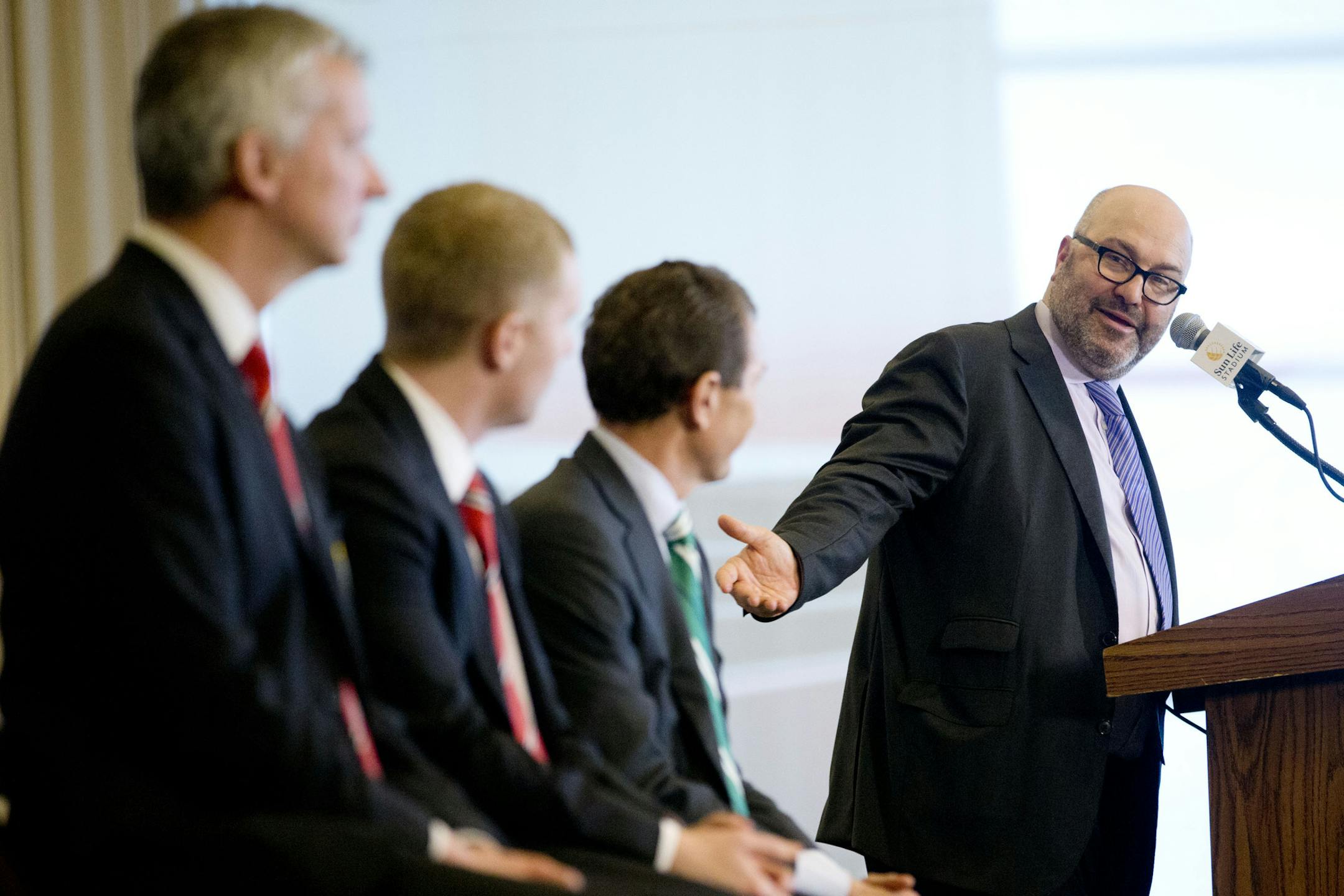 Charlie Stillitano, right, CEO of Relevent Sports, gestures towards former soccer players and club ambassadors during the announcement of the lineup for the 2014 Guinness International Cup soccer tournament during a news conference at Sun Life Stadium in Miami Gardens, Fla. From left, Manchester United director of communications Phil Townsend, Paul Scholes, Manchester United; and Emilio Butragueno with Real Madrid. The eight teams which will compete in the tournament in different cities in the U