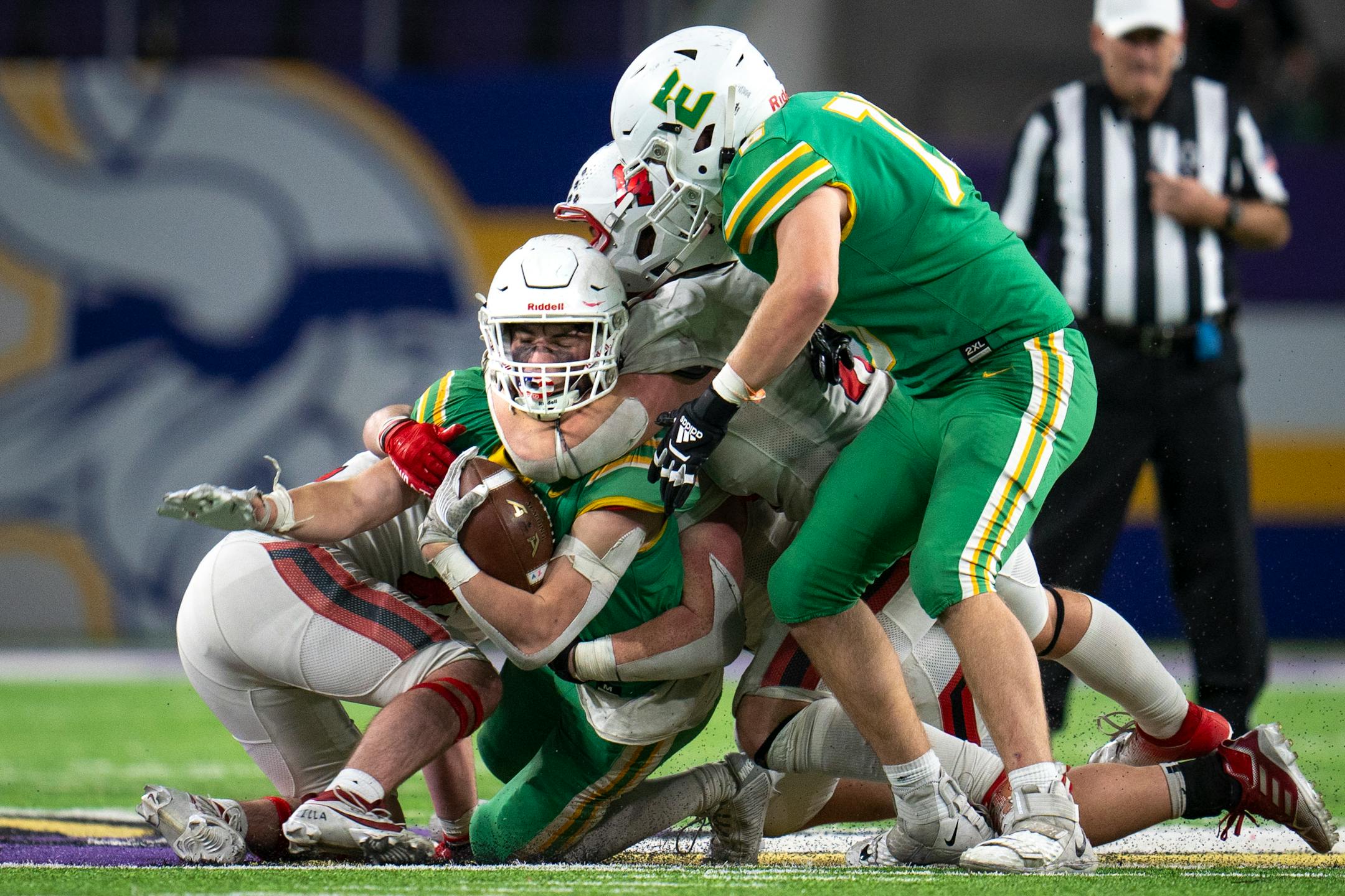 Edina High School tries to maintain possession against Centennial High School players at the 6a Championship game at U.S. Bank Stadium for the Prep Bowl XLI in Minneapolis on Friday, Nov. 24, 2023. ] Angelina Katsanis • angelina.katsanis@startribune.com