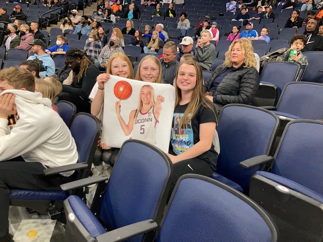 From left to right, Olivia Hammer, Bailey Johnson and Avery Frier, all seventh graders from New Ulm, cheer on UConn guard Paige Bueckers at open practice Saturday. “My motivation is Paige, and I want to be just like her,” Olivia said. “I want girls watching me just like I watch Paige.”