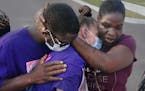 Ricky Franklin and his wife, Caylenn Franklin, center, are comforted by Anglea Jackson on Aug. 6 in West Memphis, Ark. The Franklins' 11-year-old daug