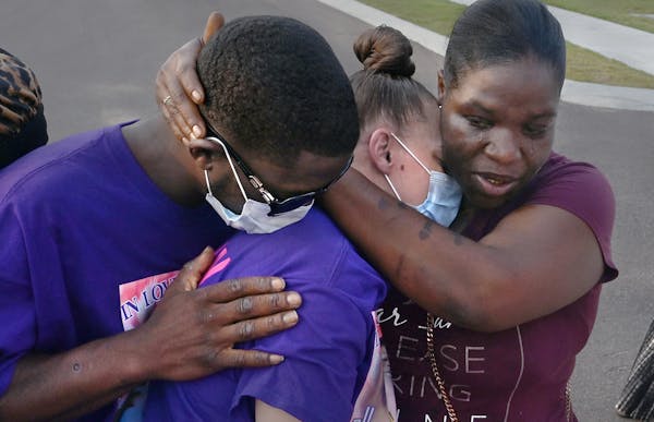 Ricky Franklin and his wife, Caylenn Franklin, center, are comforted by Anglea Jackson on Aug. 6 in West Memphis, Ark. The Franklins' 11-year-old daug