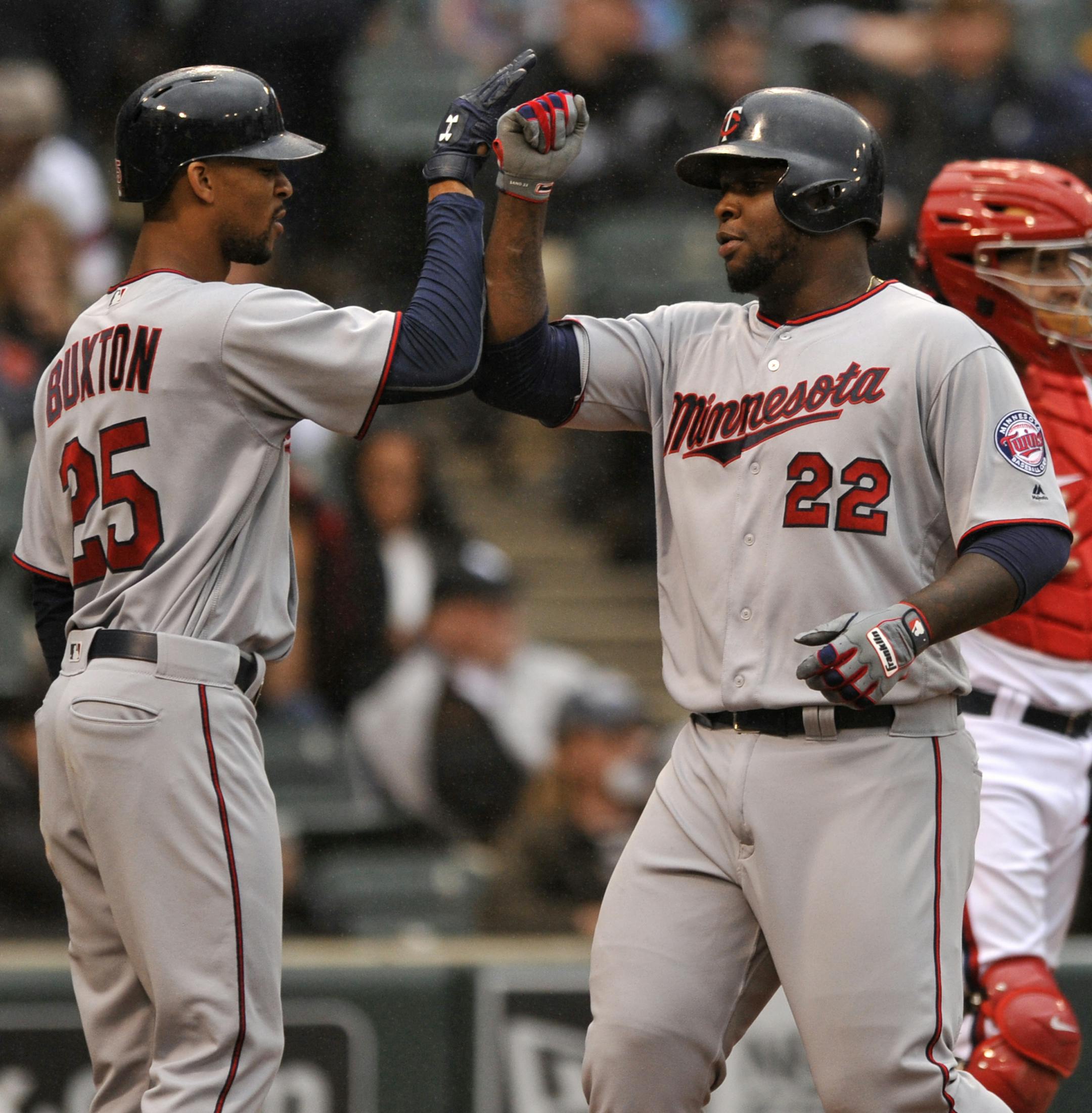 Minnesota Twins' Miguel Sano (22) celebrates with teammate Byron Buxton (25) after hitting a three-run home run during the third inning of a baseball game against the Chicago White Sox, Sunday, Oct. 2, 2016, in Chicago. (AP Photo/Paul Beaty)