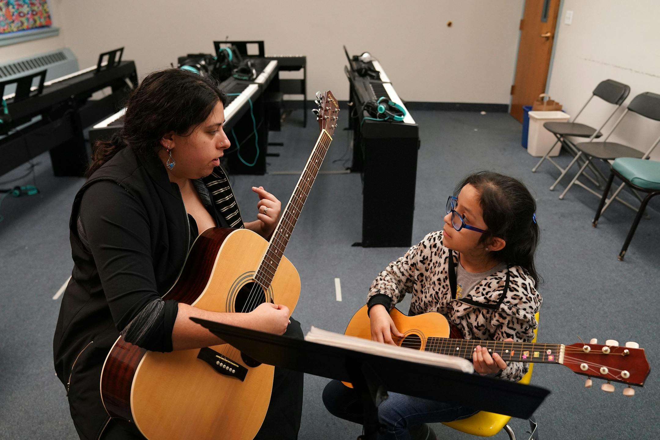 Instructor Wendy Johnson worked with Erika Estrada, 9, during her guitar lesson Wednesday evening at Hopewell Music.