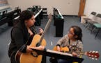 Instructor Wendy Johnson worked with Erika Estrada, 9, during her guitar lesson Wednesday evening at Hopewell Music.