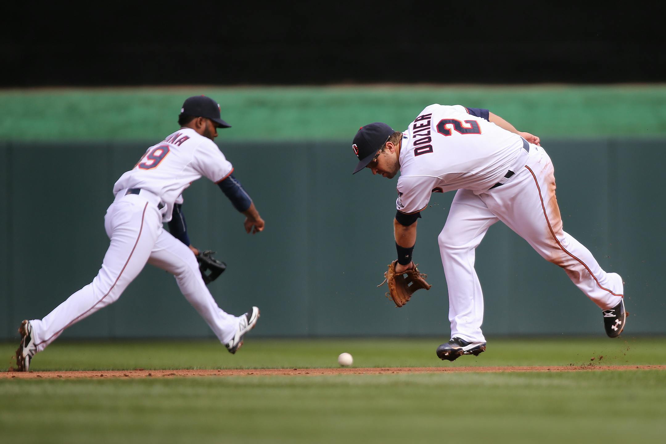 Brian Dozier, right, and Danny Santana miss a fielder during the Twins home opener against the Kansas City Royals at Target Field in Minneapolis on Monday, April 13, 2015. ] LEILA NAVIDI leila.navidi@startribune.com /