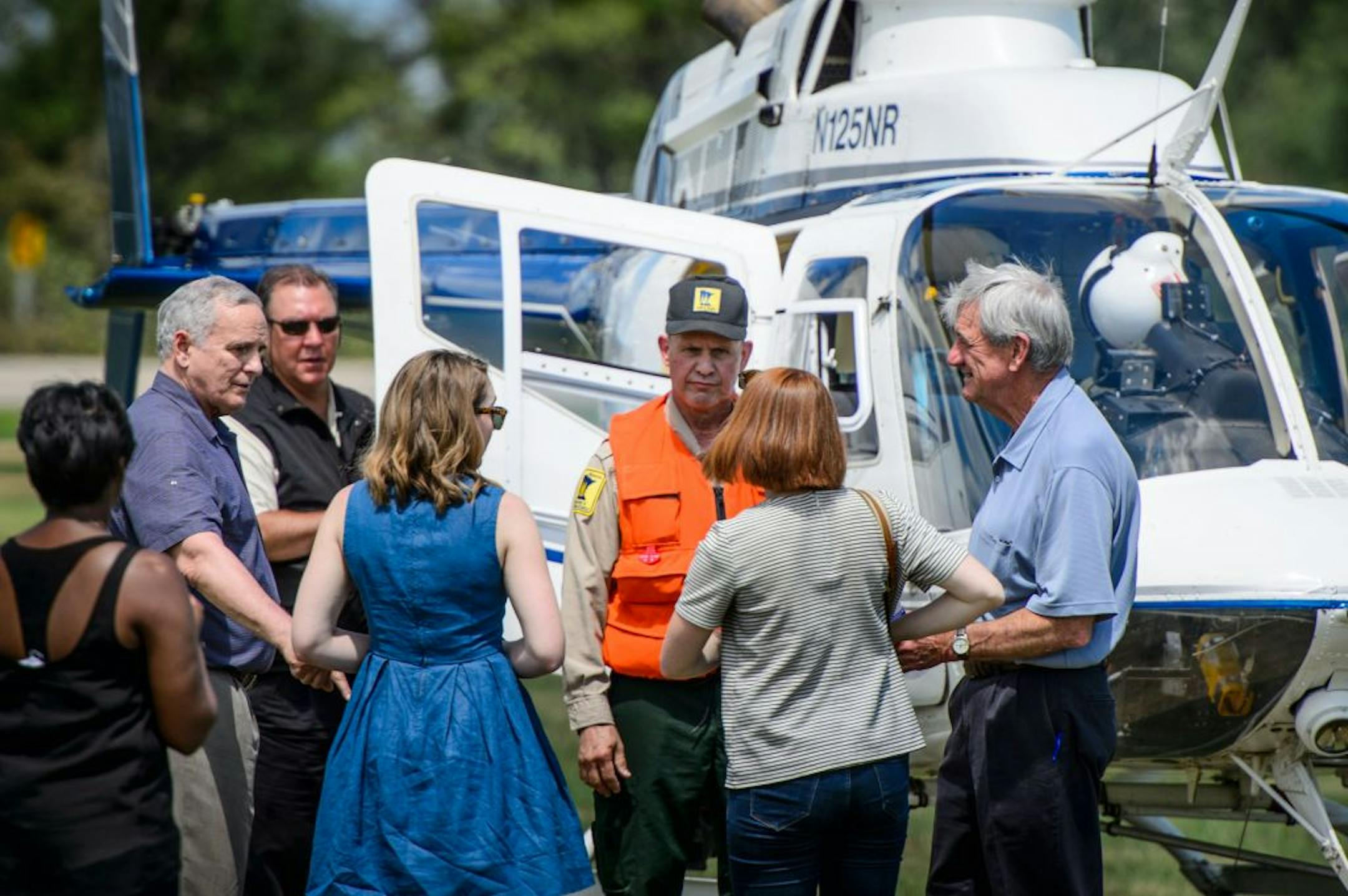 Gov. Mark Dayton, second left, and Rep. Rick Nolan, D-Minn., right, use a state helicopter in Nisswa, Minn. to survey the damage from recent storms to the Brainerd Lakes area on Friday, July 17, 2015. (Glen Stubbe/Star Tribune via AP) ST. PAUL PIONEER PRESS OUT; MAGS OUT; TWIN CITIES LOCAL TELEVISION OUT; MANDATORY CREDIT