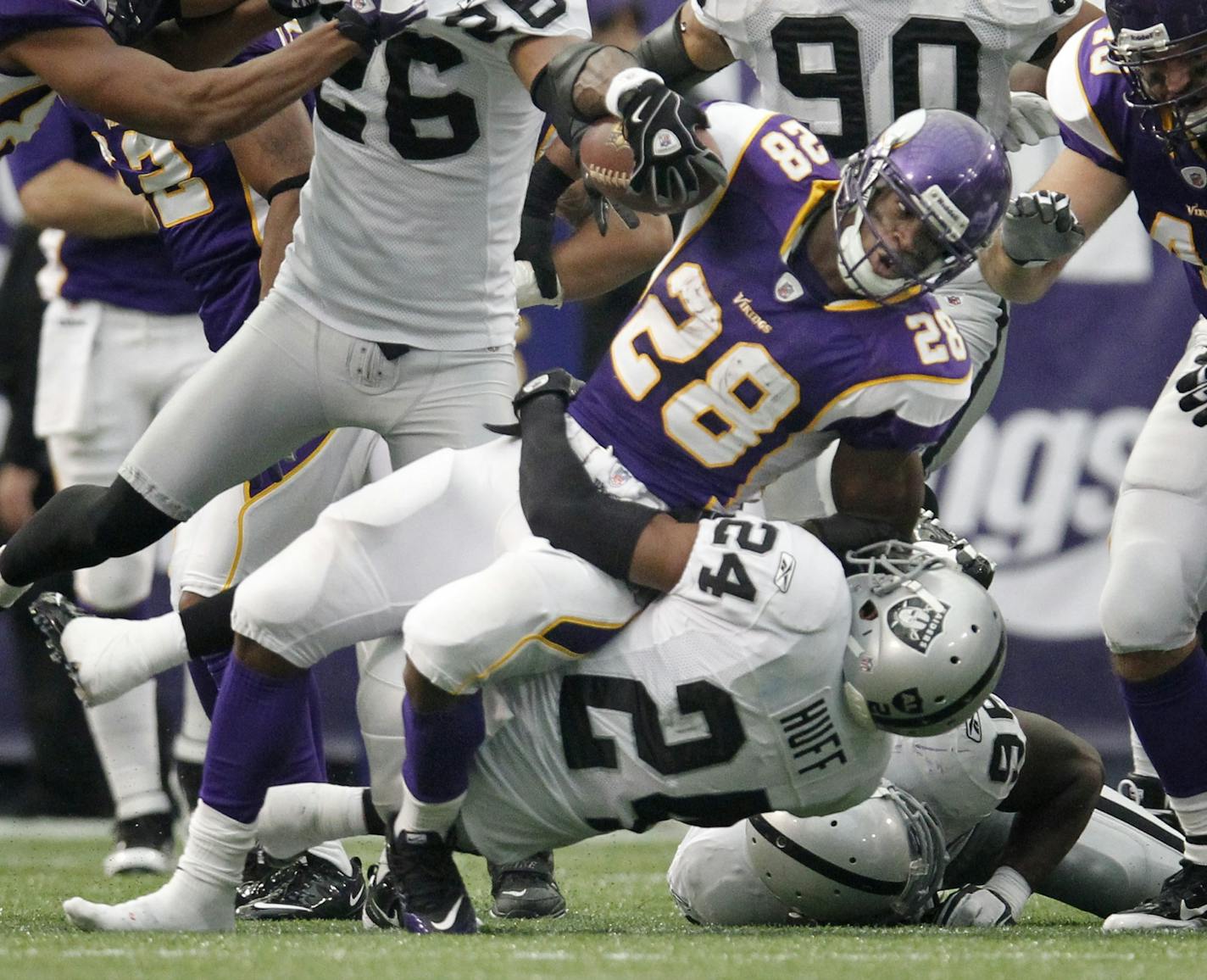 Adrian Peterson injured his ankle while he was tackled by Oakland's Michael Huff (24) on this play Nov. 20.