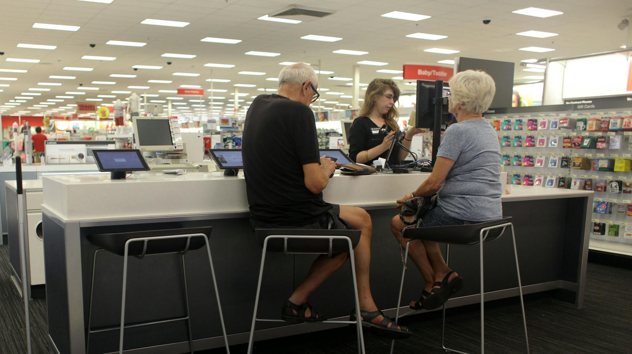 Target customers sit at a counter in the electronics section of the store. The counter is a new feature being tested at the New Brighton Blvd. Target store. ] MONICA HERNDON monica.herndon@startribune.com Minneapolis, MN 06/18/2014