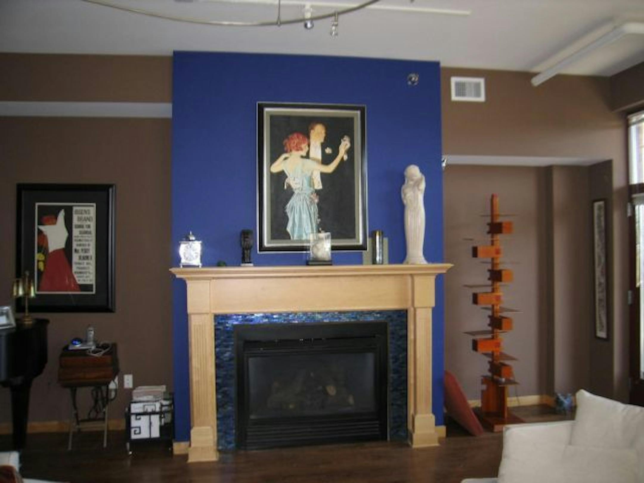 Before: Dated peacock and rust-colored living room