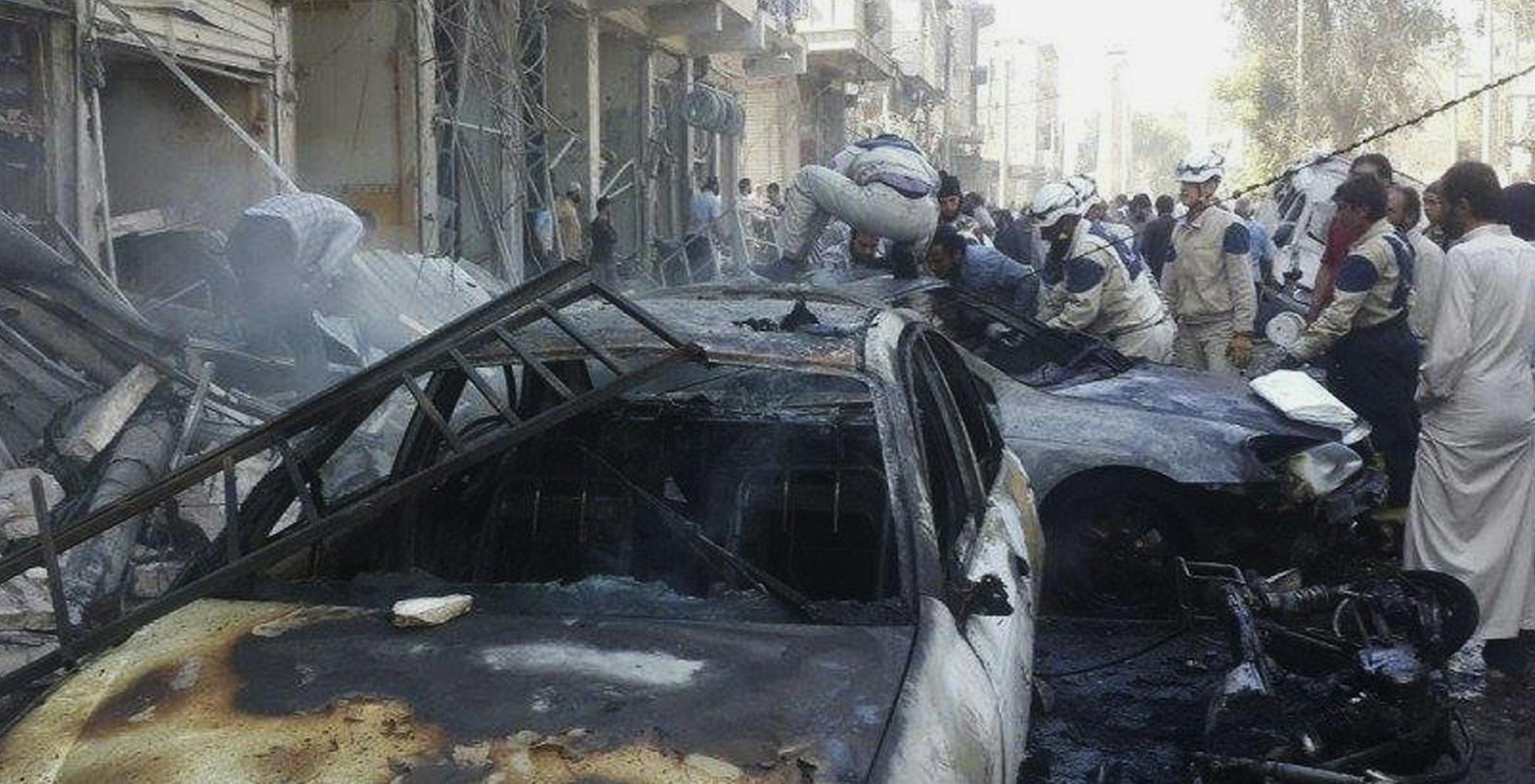 In this picture released by the Rased News Network, a Facebook account affiliated with Islamic State militants, which has been authenticated based on its contents and other AP reporting, people gather around the rubble of building and destroyed vehicles after an airstrike in Al-Bab on the outskirts of Aleppo, Syria, Monday, Oct. 5, 2015. The Britain-based Syrian Observatory for Human rights said warplanes believed to be Russian have targeted the northern town of Al-Bab that is a stronghold of th