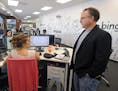 Kevin Buerger, right, executive VP of Jellyfish, a UK-based Internet marketing company, talks with Kelly Pollhammer, left, at the company's U.S. headq