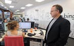 Kevin Buerger, right, executive VP of Jellyfish, a UK-based Internet marketing company, talks with Kelly Pollhammer, left, at the company's U.S. headq