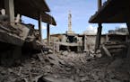 A picture taken on September 30, 2015 shows damaged buildings and a minaret in the central Syrian town of Talbisseh in the Homs province. Russian warp