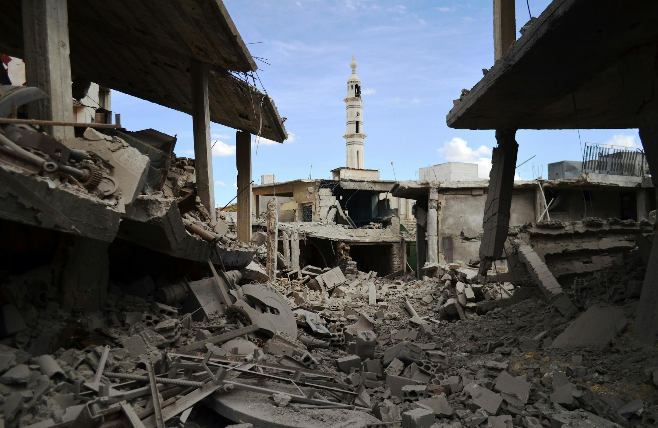 A picture taken on September 30, 2015 shows damaged buildings and a minaret in the central Syrian town of Talbisseh in the Homs province. Russian warplanes carried out air strikes in three Syrian provinces, including Homs, along with regime aircraft on September 30, according to a Syrian security source. Earlier in the day, the Syrian Observatory for Human Rights, a Britain-based monitor, reported at least 27 civilians had been killed in air strikes in the Homs province, adding that the strikes