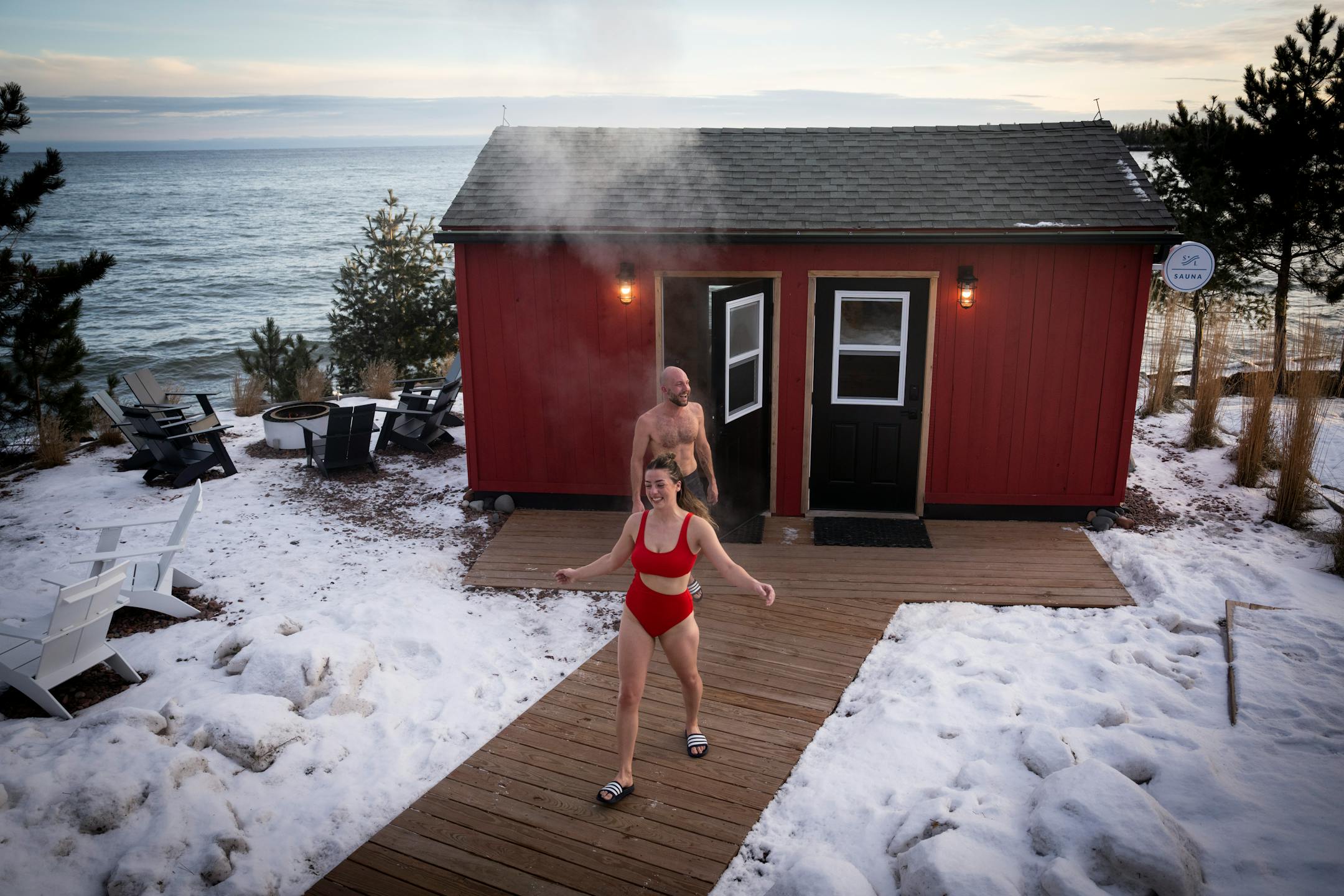 Ana Macy and Sven Hoaglund leave their hot sauna to go through the alley to take a dip in the public access area of Lake Superior at Sisu and Löyly Sauna.